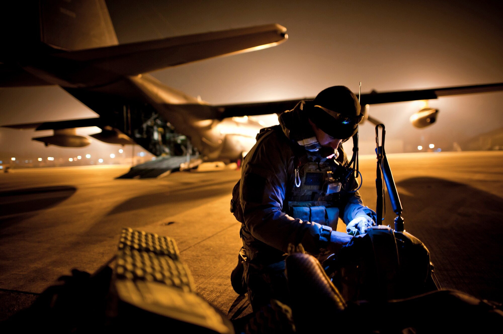Tech. Sgt. Ray Decker prepares his rucksack prior to boarding an MC-130P Combat Shadow March 16, 2011, at Yokota Air Base, Japan. Sergeant Decker is from the 320th Special Tactics Squadron at Kadena AB, Japan. (U.S. Air Force photo/Staff Sgt. Samuel Morse)