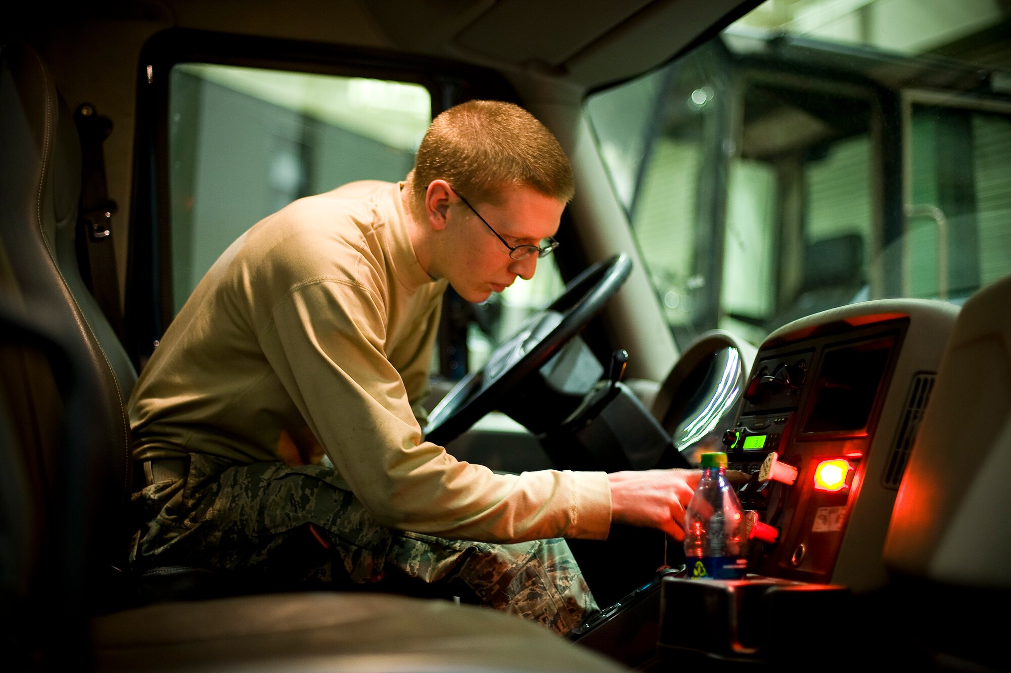 YOKOTA AIR BASE, Japan -- Airman 1st Class James Adams, 673rd Logistics Readiness Squadron vehicle maintenance specialist, stationed out of Elmendorf Air Force Base, Alaska, tests the hydraulic switches on a truck here March 23. "The mission in Japan right now is extremely important. I am so proud to be a part of it." (U.S. Air Force photo/Staff Sgt. Chad C. Strohmeyer)