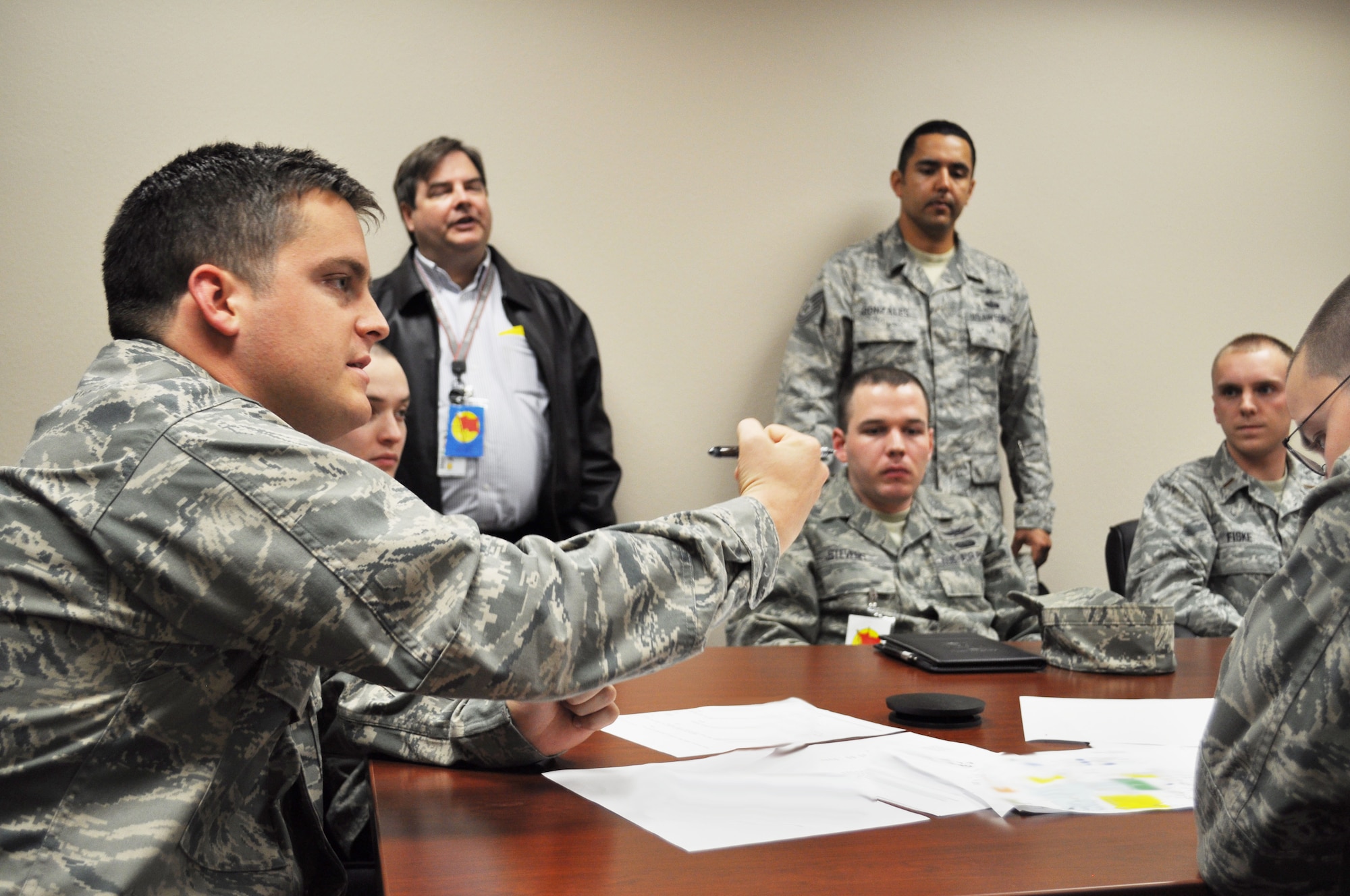 1st Lt. Nathan Kane, 26th Network Operations Squadron, talks during the Red Flag blue team debrief at Lackland Air Force Base March 7. Lieutenant Kane acted as a network defender during the exercise. This was the first time cyber operators had an active role on the blue team. (Photo illustration by Tech. Sgt. Scott McNabb)