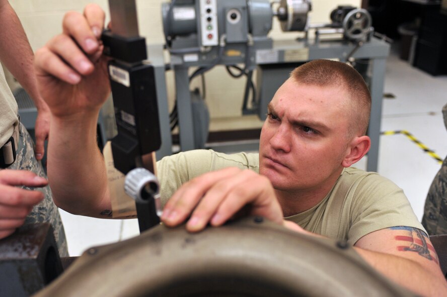 WHITEMAN AIR FORCE BASE, Mo. -- Airman 1st Class Steven Evanitus, 509th Maintenance Squadron hydraulic systems journeyman, measures a torque tube from a B-2 Spirit brake system March 22, 2011. Airman Evanitus performed the precision measurement during the repair of a B-2 brake system to ensure the part was still within tolerance. (U.S. Air Force photo by Tech. Sgt. Charles Larkin Sr)