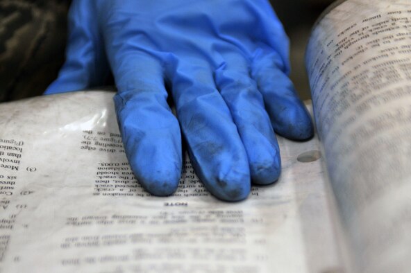 WHITEMAN AIR FORCE BASE, Mo. -- Airman 1st Class Travis Dowler, 509th Maintenance Squadron hydraulic systems apprentice, reads a technical order used to repair a B-2 Spirit brake system March 22, 2011. Airman Dowler assisted the repair of a brake system during his on-the-job training. (U.S. Air Force photo by Tech. Sgt. Charles Larkin Sr)

