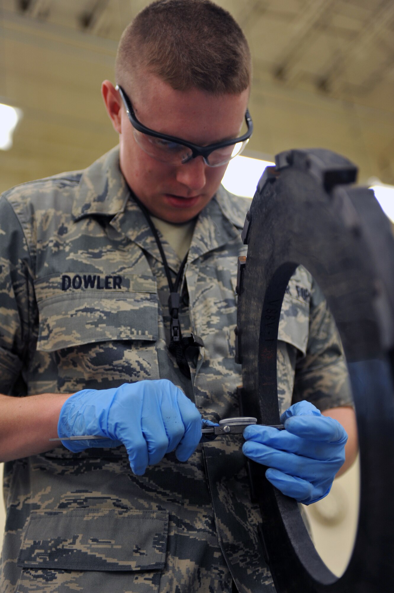 WHITEMAN AIR FORCE BASE, Mo. -- Airman 1st Class Travis Dowler, 509th Maintenance Squadron hydraulic systems apprentice, measures tolerances on a heat stack from a B-2 Spirit brake system March 22, 2011. Airman Dowler received on-the-job training to repair B-2 brake systems during their daily operations. (U.S. Air Force photo by Tech. Sgt. Charles Larkin Sr)  