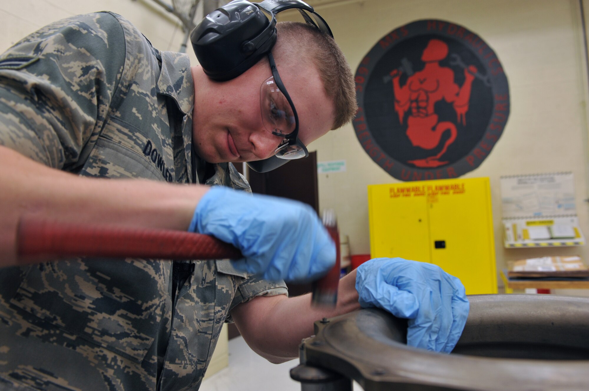 WHITEMAN AIR FORCE BASE, Mo. -- Airman 1st Class Travis Dowler, 509th Maintenance Squadron hydraulic systems apprentice, hammers a rivet on a torque tube from a B-2 Spirit brake system March 22, 2011. Airman Dowler received instructions and performed repairs to the B-2's brake system during his on-the-job training. (U.S. Air Force photo by Tech. Sgt. Charles Larkin Sr)