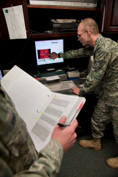 Staff Sgt. Ryan Snider, 23rd Operations Support Squadron weather forecaster, shows examples of radar alert categories March 24 at the 23rd OSS base operations building, Moody Air Force Base, Ga. Throughout the week, a Standardization and Evaluation Program for Weather Operations team evaluated the weather flight on their processes, procedures and mission support effectiveness. (U.S. Air Force photo/Staff Sgt. Jamal D. Sutter)(RELEASED)