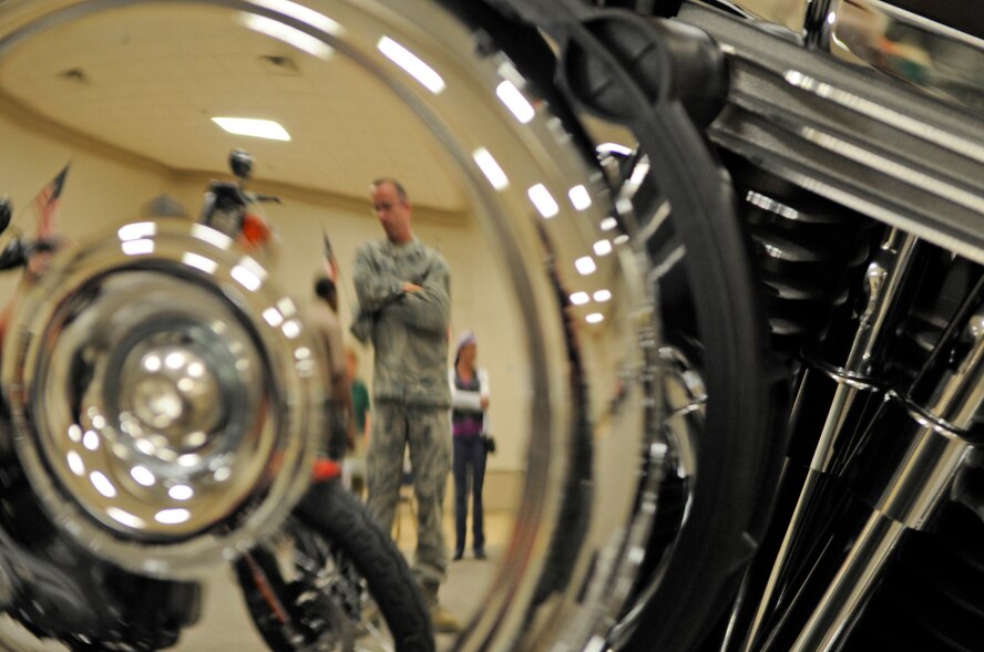 Master Sgt. Craig Matherly, 2nd Aircraft Maintenance Squadron, admires some of the new Harley Davidson motorcycles in Hoban Hall during a motorcycle rally on Barksdale Air Force Base, La., March 23. More than 75 Airmen showed up for the event where they were educated on motorcycle safety and personal protective equipment. The event prepared riders for the upcoming riding season by educating them in maintenance, safety and to learn about the different kinds of bikes available for new riders. Members could also sign up for free rider courses to prepare them for the spring. (U.S. Air Force photo/Staff Sgt. John Gordinier)(Released)