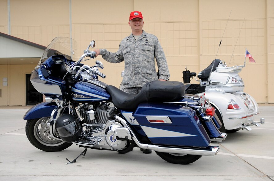 Lt. Col. Jeffrey Barnett, 307th RED HORSE Squadron commander, displays his Air Force bike during a motorcycle rally on Barksdale Air Force Base, La., March 23. More than 75 Airmen showed up for the event where they were educated on motorcycle safety and personal protective equipment. Mr. Percy Adams, Barksdale's motorcycle safety coordinator, said the event was held to prepare riders for the upcoming riding season by educating them in maintenance, safety and to learn types of bikes that are available for new riders. Members could also sign up for free rider courses to prepare them for the spring. (U.S. Air Force photo/Staff Sgt. John Gordinier)(Released)