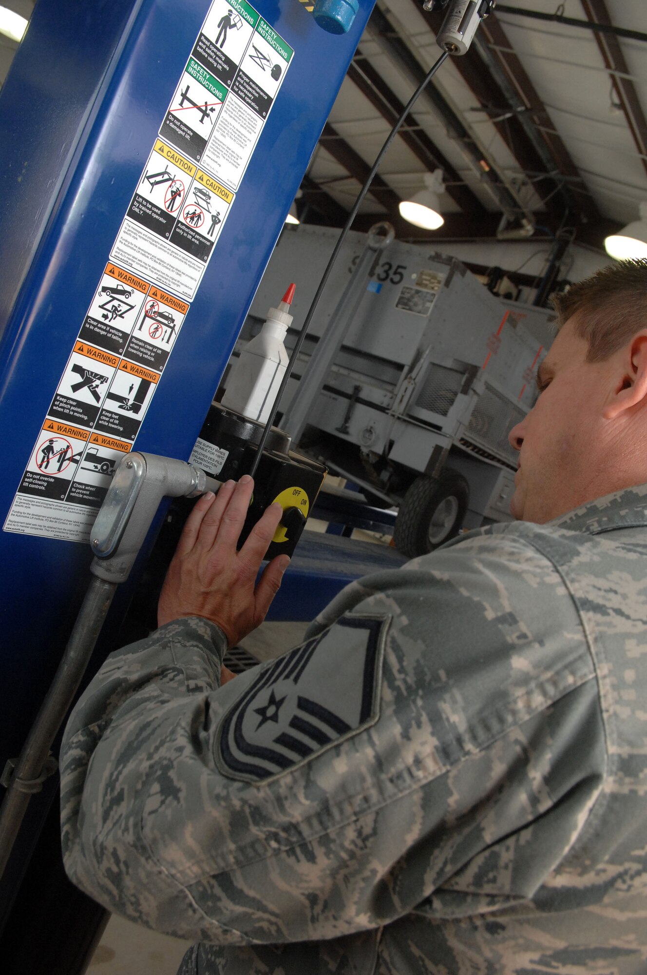 Master Sgt. Nate Barnhart, AGE flight chief, lowers a piece of aerospace ground equipment on an automotive lift inside the new AGE wash rack at Barksdale Air Force Base, La., March 23. The new AGE wash rack is scheduled to be open April 5. (U.S. Air Force Photo/Senior Airman Allison M. Boehm)(RELEASED)