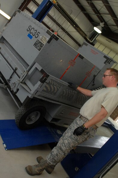Staff Sgt. Josh Wemdt, power support equipment specialist, helps maneuver aerospace ground equipment off of an automotive lift inside the new AGE wash rack at Barksdale Air Force Base, La. March 23. The new AGE wash rack is scheduled to open April 5. (U.S. Air Force Photo/Senior Airman Allison M. Boehm)(RELEASED)