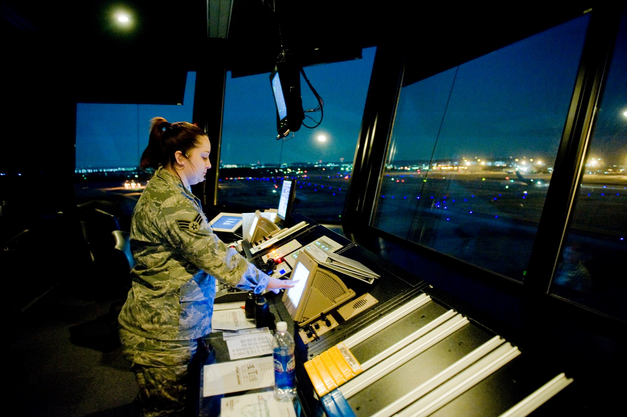 YOKOTA AIR BASE, Japan -- Senior Airman Lyndsi Tullos, 374th Operations Support Squadron air traffic controller, communicates with the Maintenance Operation Center about flight line operations here March 24. Yokota's flight line has received over triple the normal amount of aircraft due to Operation Tomodachi. The military and civilian aircraft have been from multiple nations carrying supplies, personnel and equipment in direct support of bringing relief efforts and trying to minimize human suffering. (U.S. Air Force photo/Staff Sgt. Jonathan Steffen)
