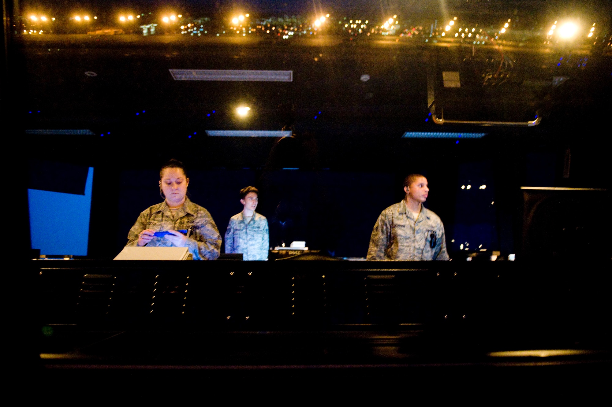 YOKOTA AIR BASE, Japan -- Senior Airman Lyndsi Tullos, Staff Sgt. Steven Valentine, and Senior Airman Nissean Johnson, 374th Operations Support Squadron air traffic controllers, maintain control of inbound and outbound aircraft here March 24. Yokota's flight line has received over triple the normal amount of aircraft due to Operation Tomodachi. The military and civilian aircraft have been from multiple nations carrying supplies, personnel and equipment in direct support of bringing relief efforts and trying to minimize human suffering. (U.S. Air Force photo/Staff Sgt. Jonathan Steffen)
