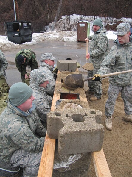 934th Security Forces Squadron members build sandbag barriers around buildings at the firing range at Minneapolis St. Paul International Airport Air Reserve station in prepration for rising flood waters. (Air Force Photo/Breeanna Martinez) 