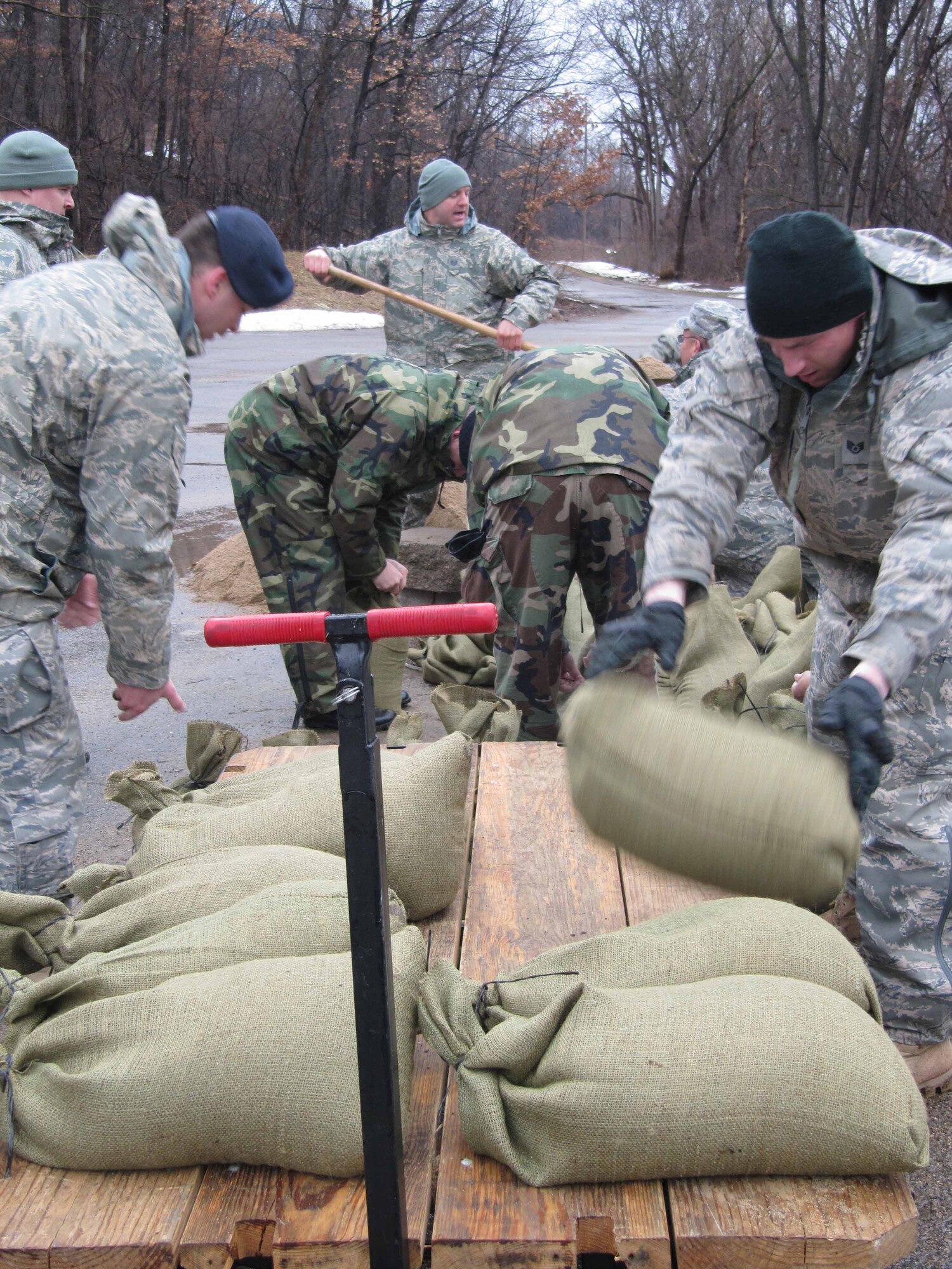 934th Security Forces Squadron members build sandbag barriers around buildings at the firing range at Minneapolis St. Paul International Airport Air Reserve station in prepration for rising flood waters. (Air Force Photo/Breeanna Martinez) 
