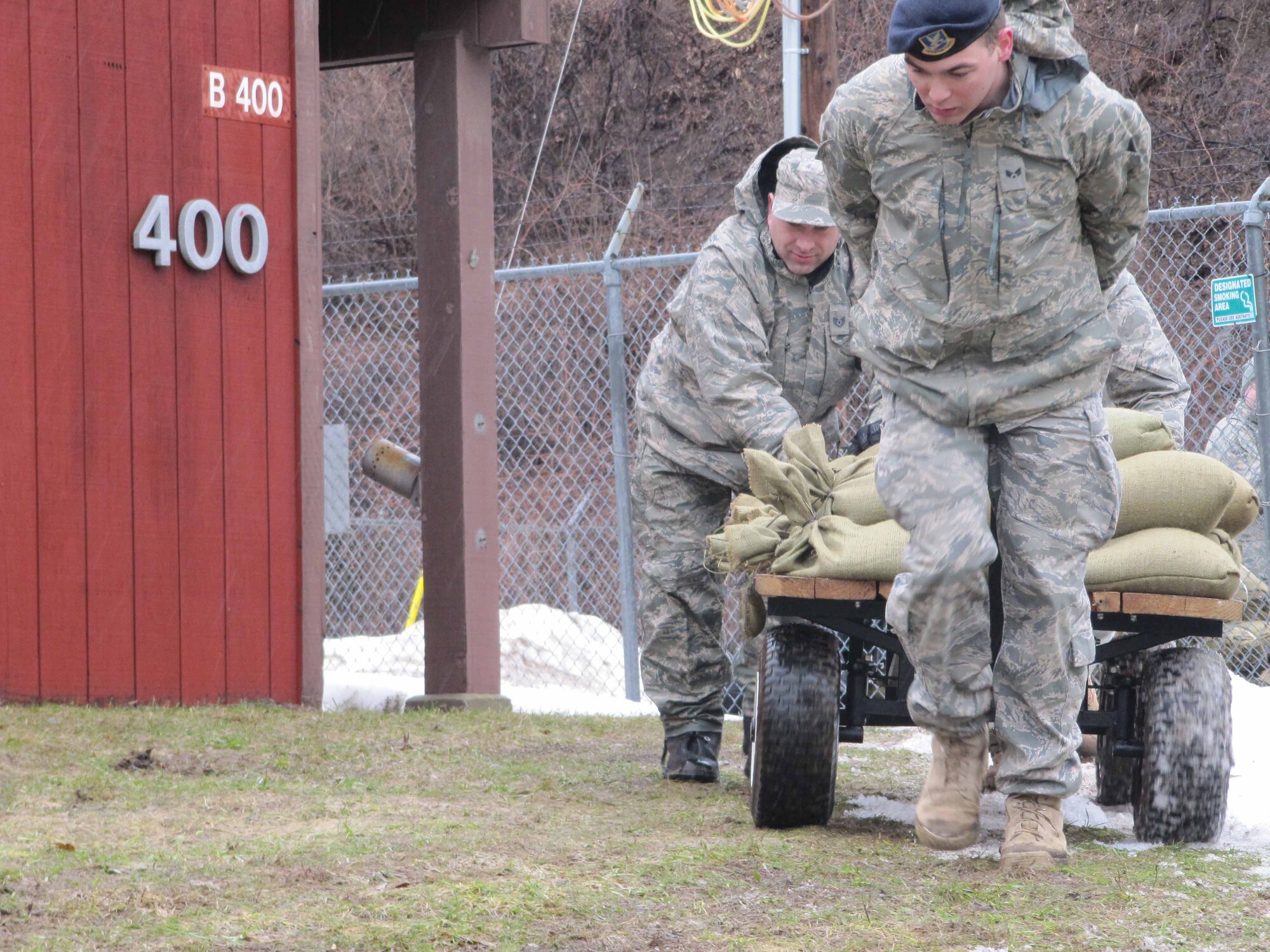 934th Security Forces Squadron members build sandbag barriers around buildings at the firing range at Minneapolis St. Paul International Airport Air Reserve station in prepration for rising flood waters. (Air Force Photo/Breeanna Martinez) 