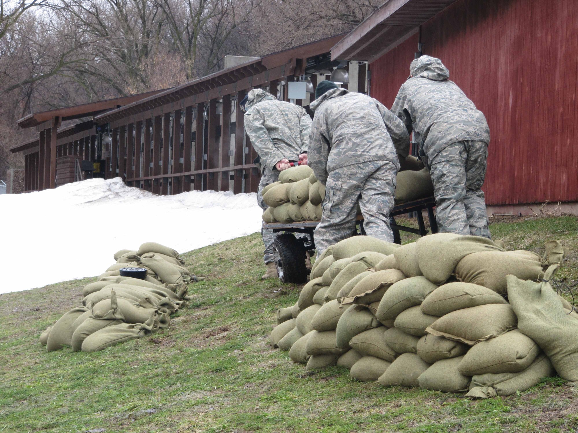 934th Security Forces Squadron members build sandbag barriers around buildings at the firing range at Minneapolis St. Paul International Airport Air Reserve station in prepration for rising flood waters. (Air Force Photo/Breeanna Martinez) 