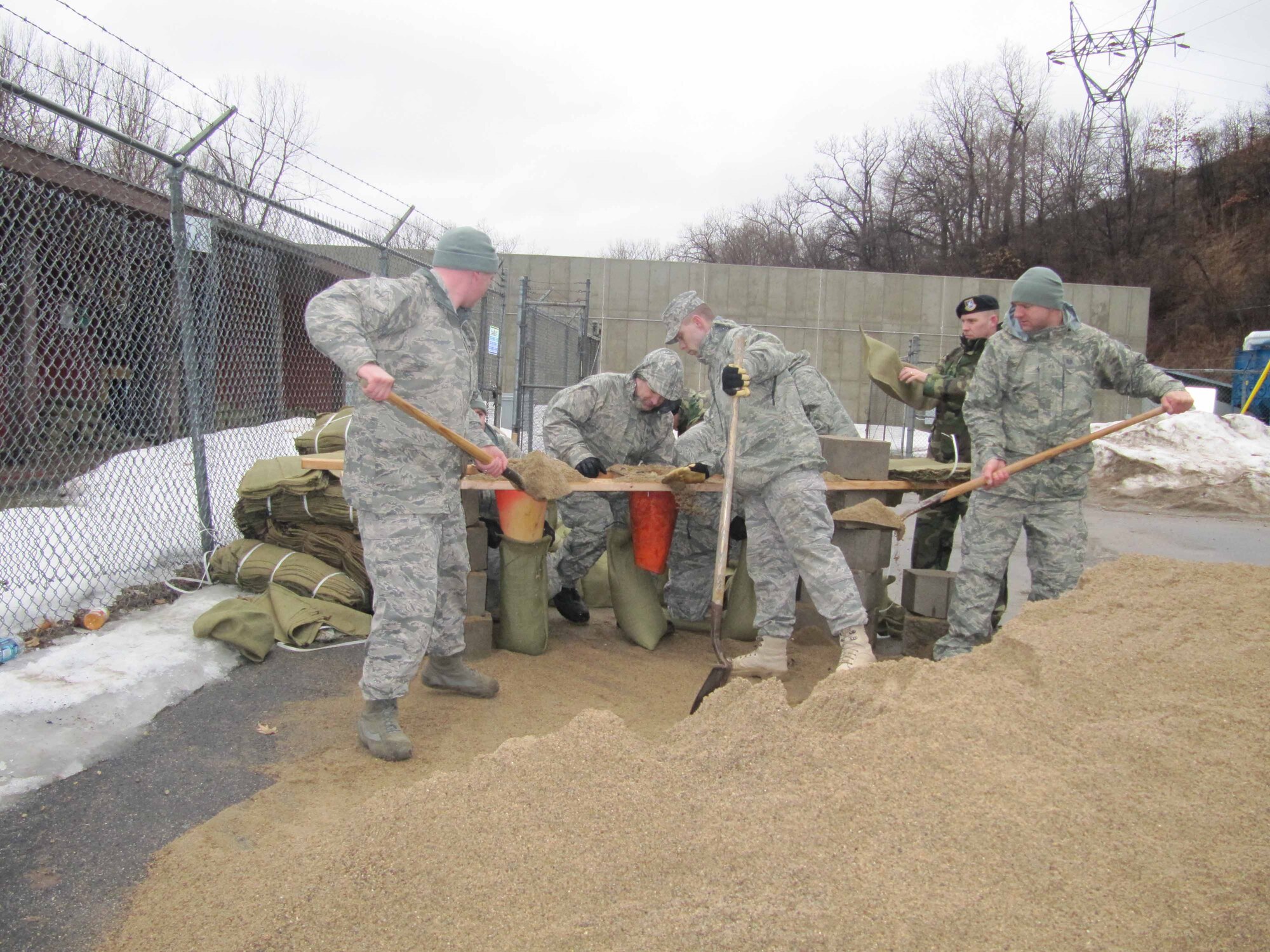 934th Security Forces Squadron members build sandbag barriers around buildings at the firing range at Minneapolis St. Paul International Airport Air Reserve station in prepration for rising flood waters. (Air Force Photo/Breeanna Martinez) 