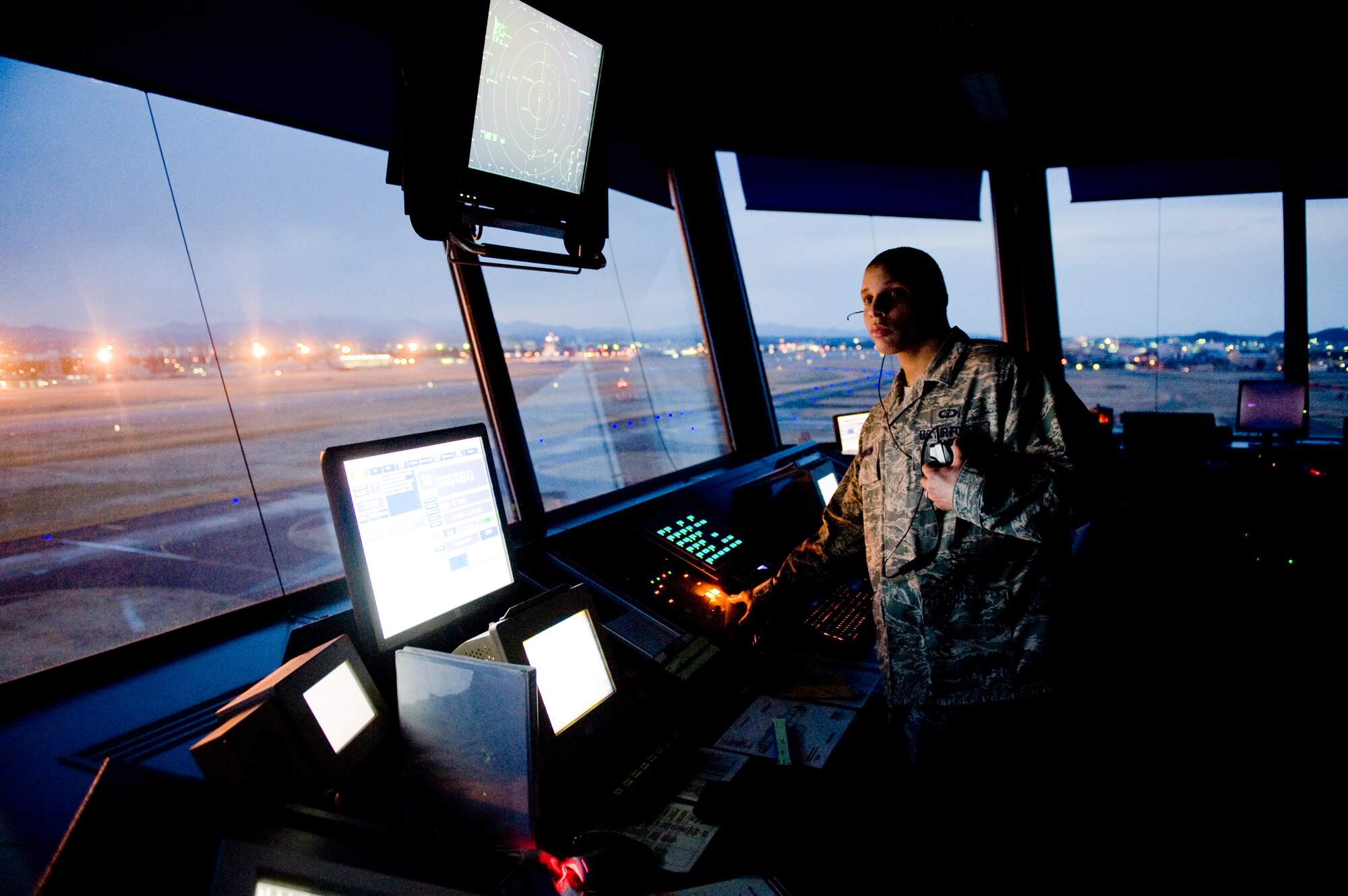 YOKOTA AIR BASE, Japan -- Senior Airman Nissean Johnson, 374th Operations Support Squadron air traffic controller, watches the flight line and sky for incoming and outgoing aircraft here March 24. Yokota's flight line has received over triple the normal amount of aircraft due to Operation Tomodachi. The military and civilian aircraft have been from multiple nations carrying supplies, personnel and equipment in direct support of bringing relief efforts and trying to minimize human suffering. (U.S. Air Force photo/Staff Sgt. Jonathan Steffen)