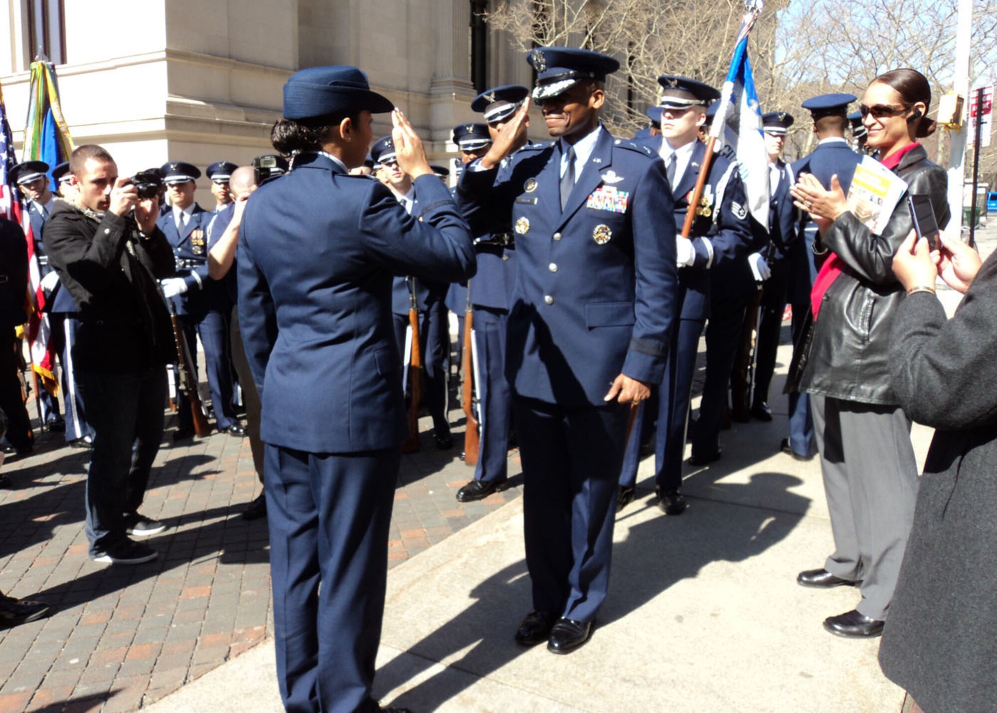 NEW YORK – Capt. Gina Beinhaur (left) salutes Maj. Gen. Darren W. McDew, commander, Air Force District of Washington, after accepting a coin from him following the St. Patrick’s Day parade. General McDew told the Airmen he was proud of how they represented the Air Force during the parade. (Courtesy photo)