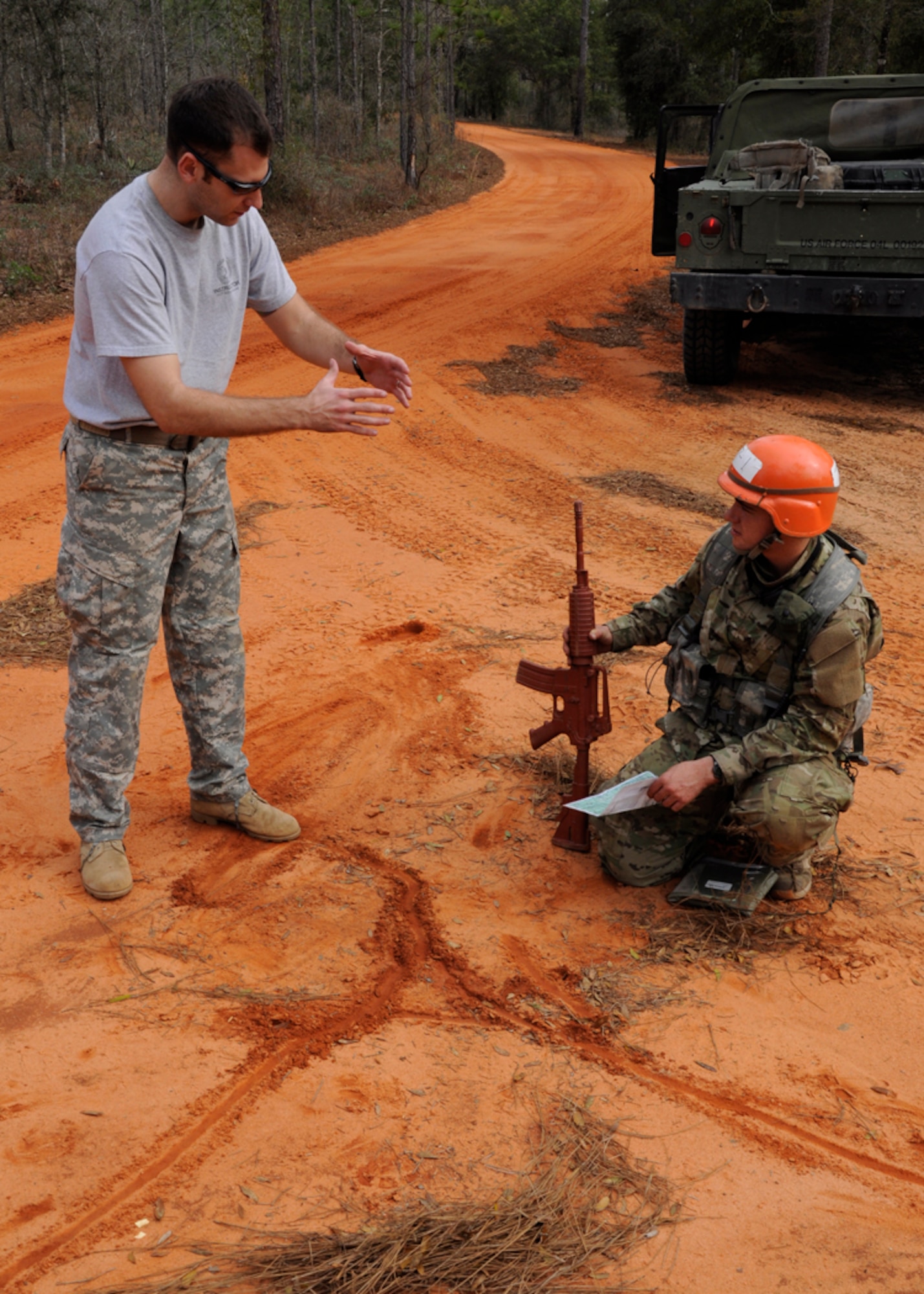 Staff Sgt. Daniel Collins, a Tactical Air Control Party instructor, provides assistance to Airman Jerrod Mowery, a TACP candidate from Falcon Flight 86, while evaluating a vehicle land navigation evaluation during field training exercise week, Eglin Air Force Base Range, Fla., March 8, 2011.  The FTX, which marks the halfway point through the 17-week course, is the culmination of everything that has been taught so far. (U.S. Air Force photo by Staff Sgt. William Banton)