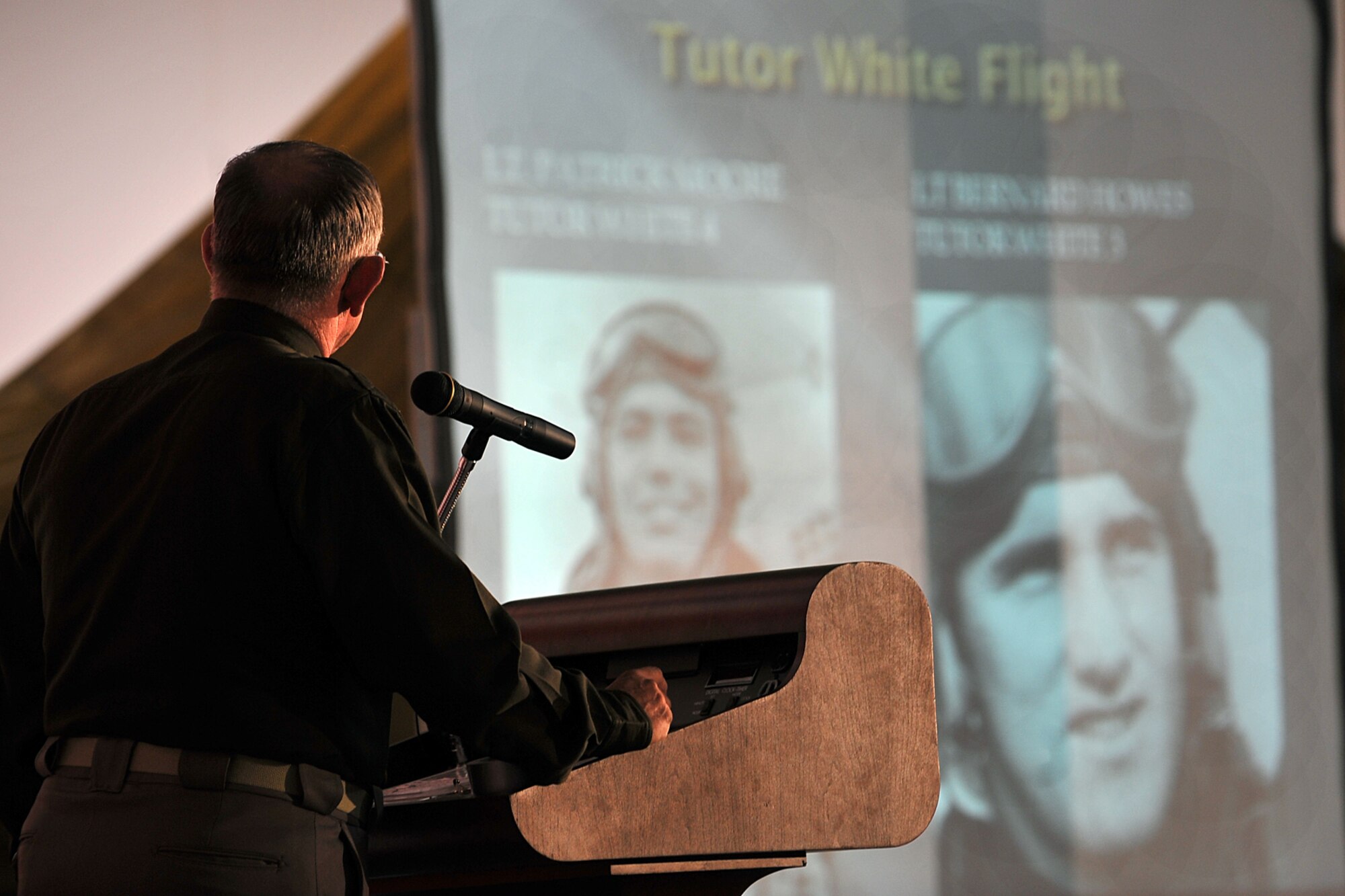 OFFUTT AIR FORCE BASE, Neb. - Retired Col. Jim Thomas, 55th Wing Association president, talks to Team Offutt about two fighter pilots who flew P-51 Mustang aircraft in World War II during the Tales of the 55th ceremony at the James M. McCoy Airman Leadership School building April 9, 2010. The event held in conjunction with the 55th Wing Heritage Week, gave Team Offutt a chance to reflect on its heritage and hear stories from those who answered their nation call. U.S. Air Force photo by Charles Haymond