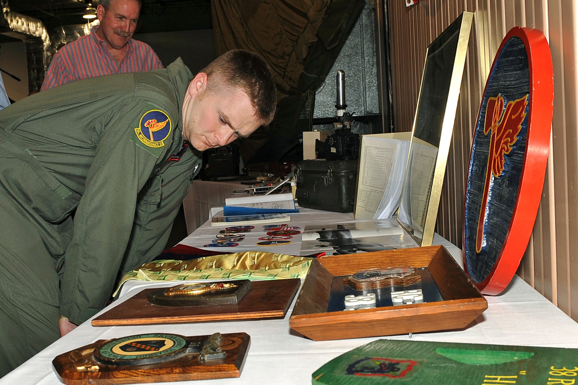 OFFUTT AIR FORCE BASE, Neb. - Staff Sgt. Sean Carter, with the 38th Reconnaissance Squadron, looks over some of the 38th RS history on display during the Tales of the 55th event at the James M. McCoy Airman Leadership School building April 9, 2010. The event held in conjunction with the 55th Wing Heritage Week, gave Team Offutt a chance to reflect on its heritage and hear stories from those who answered their nation call. U.S. Air Force photo by Charles Haymond