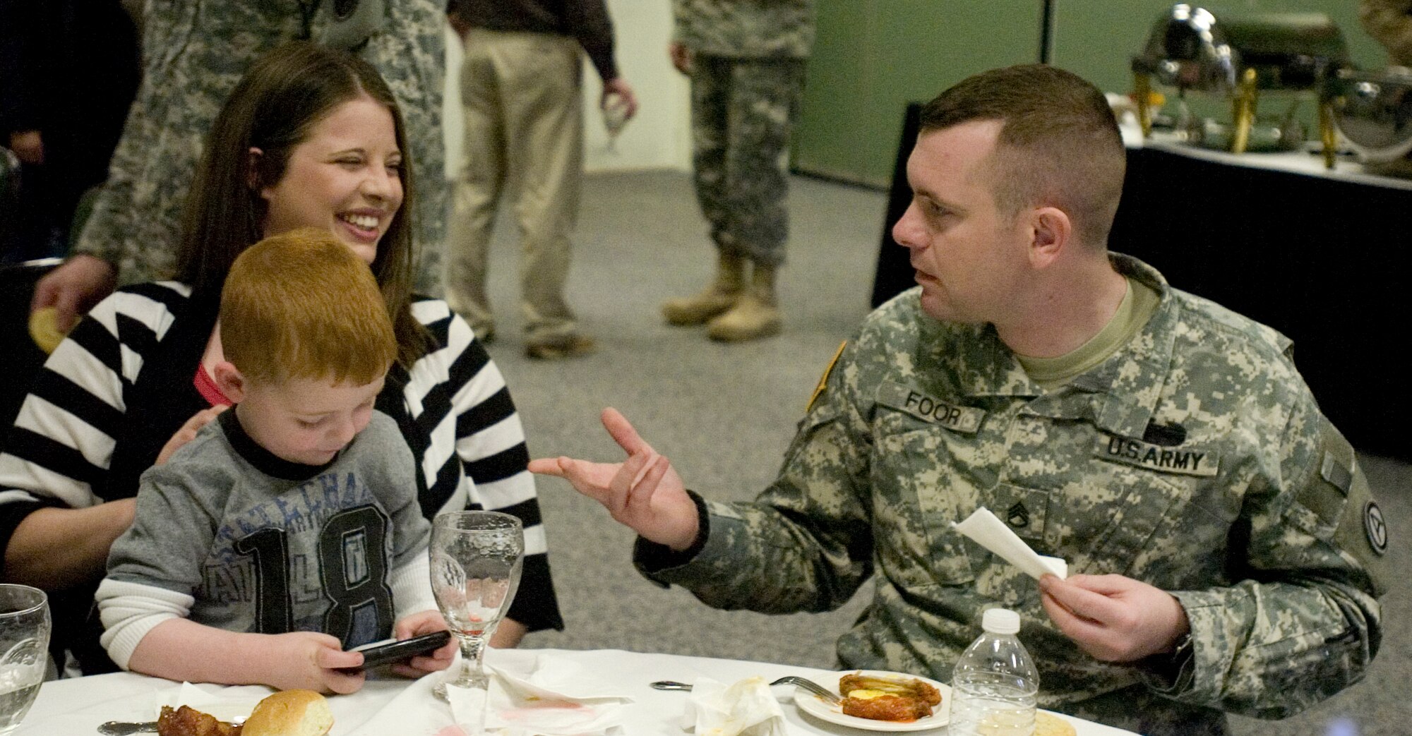 SHAW AIR FORCE BASE, SUMTER, S.C.  - Staff Sgt. Robert S. Foor, his wife Laura B.Foors and their four-year-old son, Ayden C. Foors enjoy some family time during the 4th Battlefield Coordination Detachment re-deployment ceremony at Carolina Skies Club here, March 15, 2011. Staff Sgt. Foors recently returned from a six-month deployment to Al Udeid Air Base, Qatar in support of Operation Enduring Freedom.