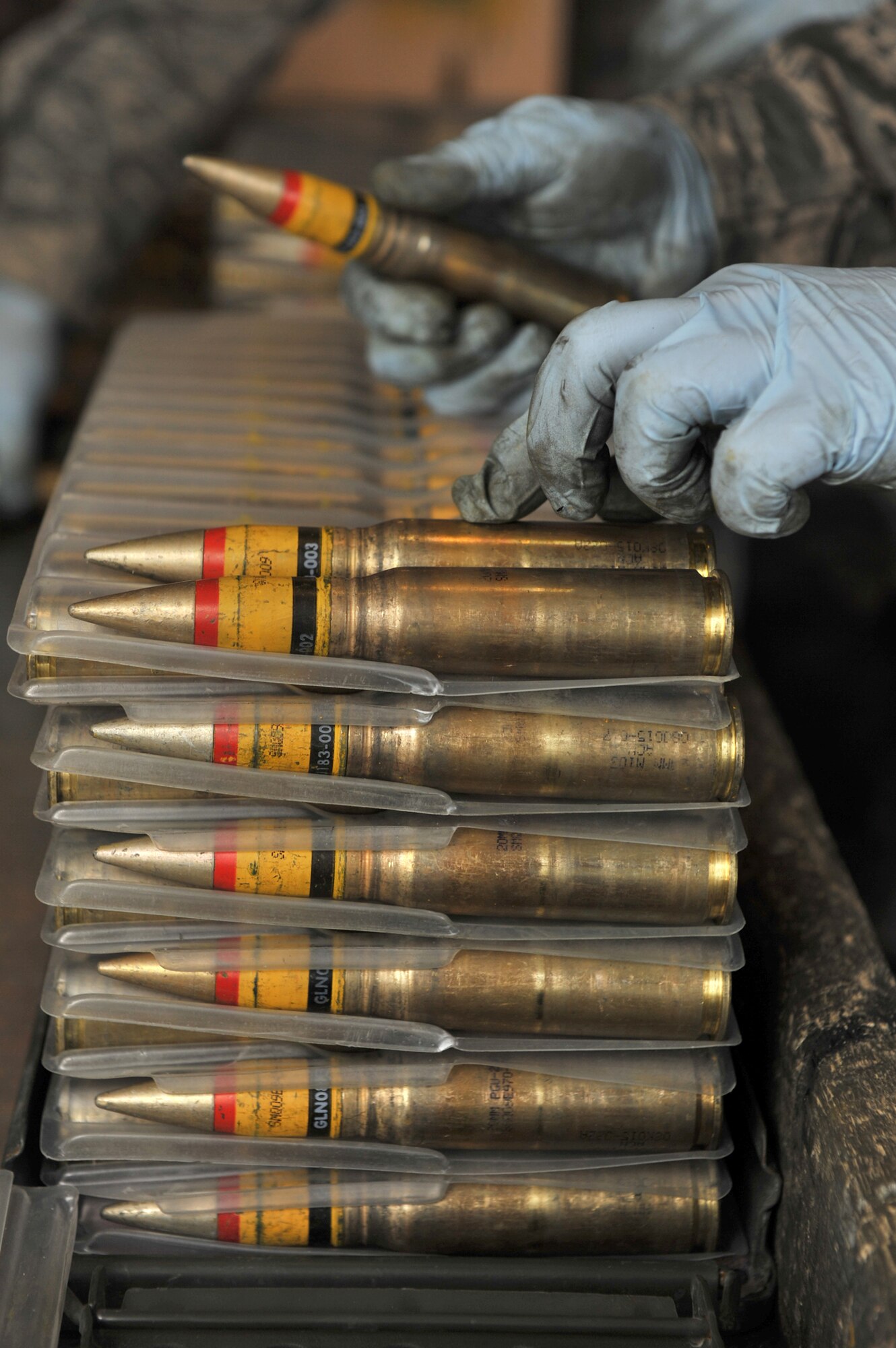 A member from the 455th Expeditionary Maintenance Squadron Ammunition Supply Point inspects 20 millimeter rounds March 23, 2011, at Bagram Airfield, Afghanistan. (U.S. Air Force photo/Senior Airman Sheila deVera) 
