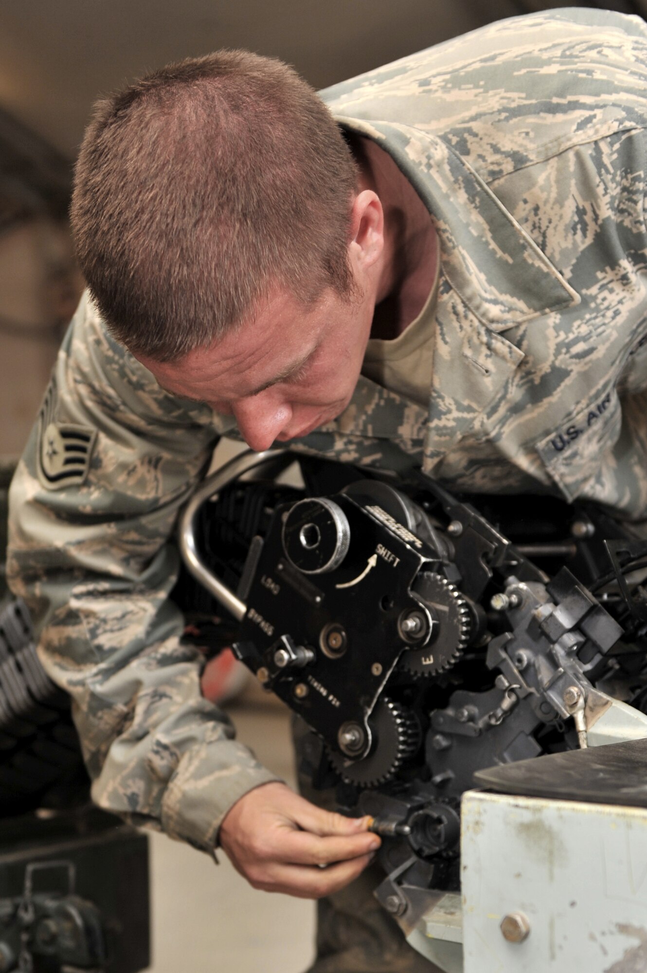 Staff Sgt. Glen Vart connects a linkless ammunition loading system to a replenisher table March 23, 2011, at Bagram Airfield, Afghanistan. The loading system allows cycling of 20 millimeter rounds for inventory and inspection. Sergeant Vart is an ammunition supply point technician assigned to the 455th Expeditionary Maintenance Squadron. (U.S. Air Force photo/Senior Airman Sheila deVera)