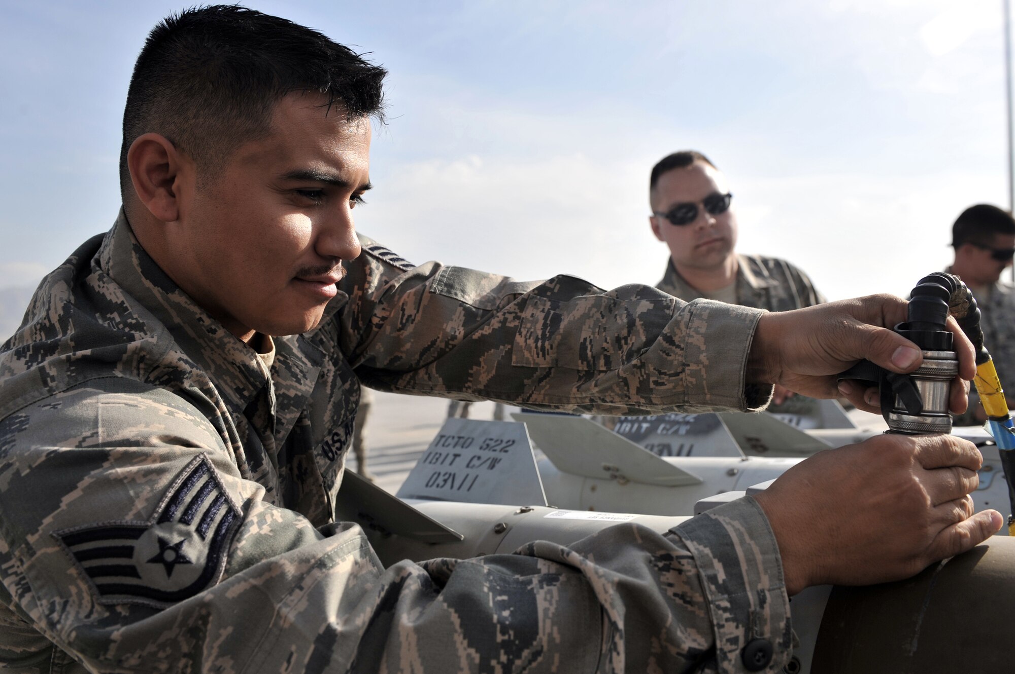 Staff Sgt. Raul Viernes connects a cable to a KMU-572 fin March 23, 2011, at Bagram Airfield, Afghanistan. Sergeant Vierness is an ammunition supply point technician assigned to the 455th Expeditionary Maintenance Squadron. (U.S. Air Force photo/Senior Airman Sheila deVera)