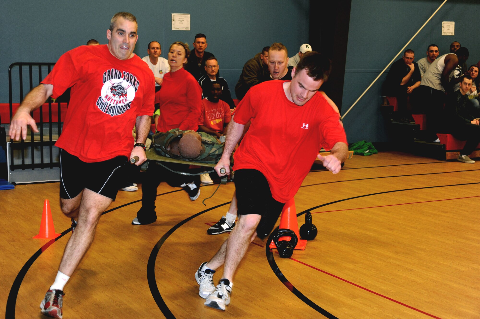 Members of the 319th Civil Engineering Squadron work together during the Kettle Bell Relay Mar. 17 at the base fitness center during the base’s annual Winter Bash competitions. (U.S. Air Force photo by Airman 1st Class Amber Bennett)
