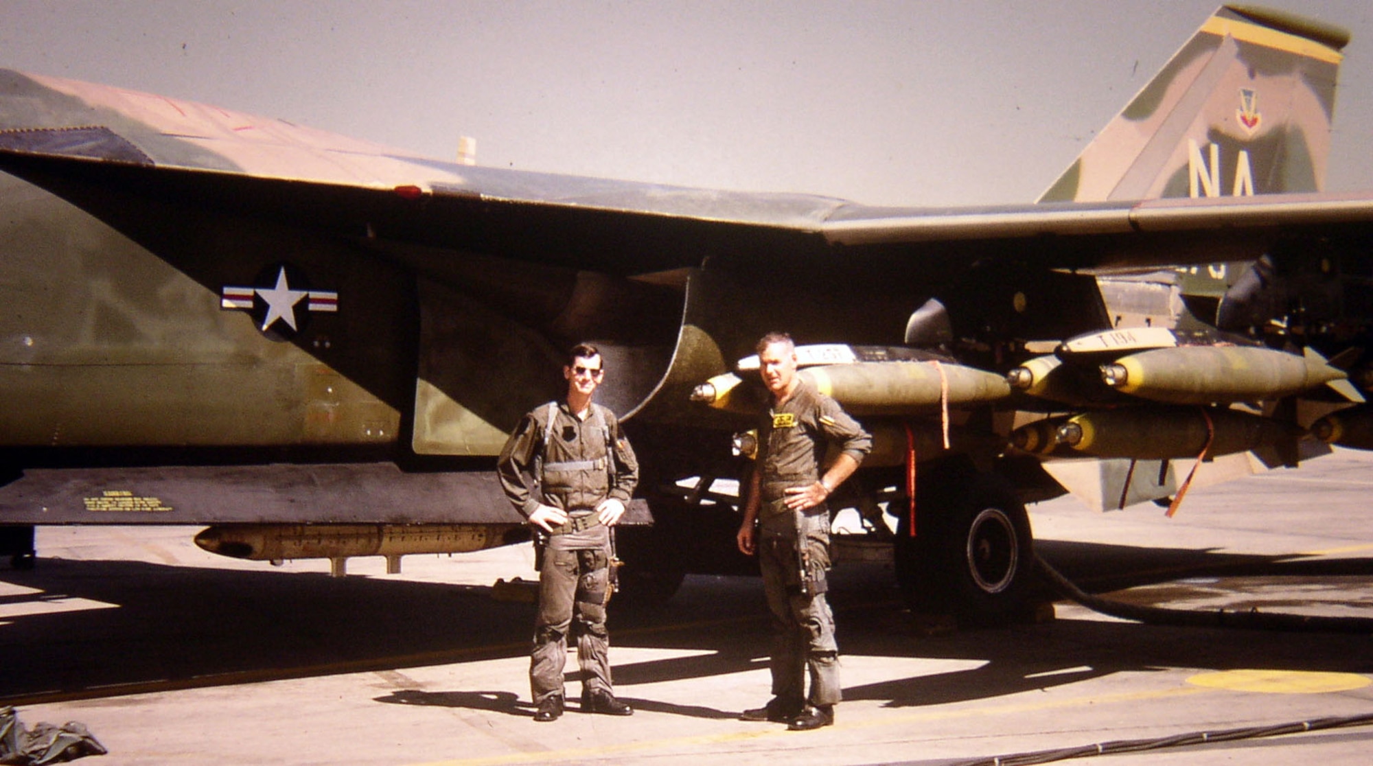 A 474th Tactical Fighter Wing F-111A aircrew stands in front of their aircraft before a mission. In September 1972, the 474th TFW deployed 48 F-111As to Thailand. (U.S. Air Force photo)