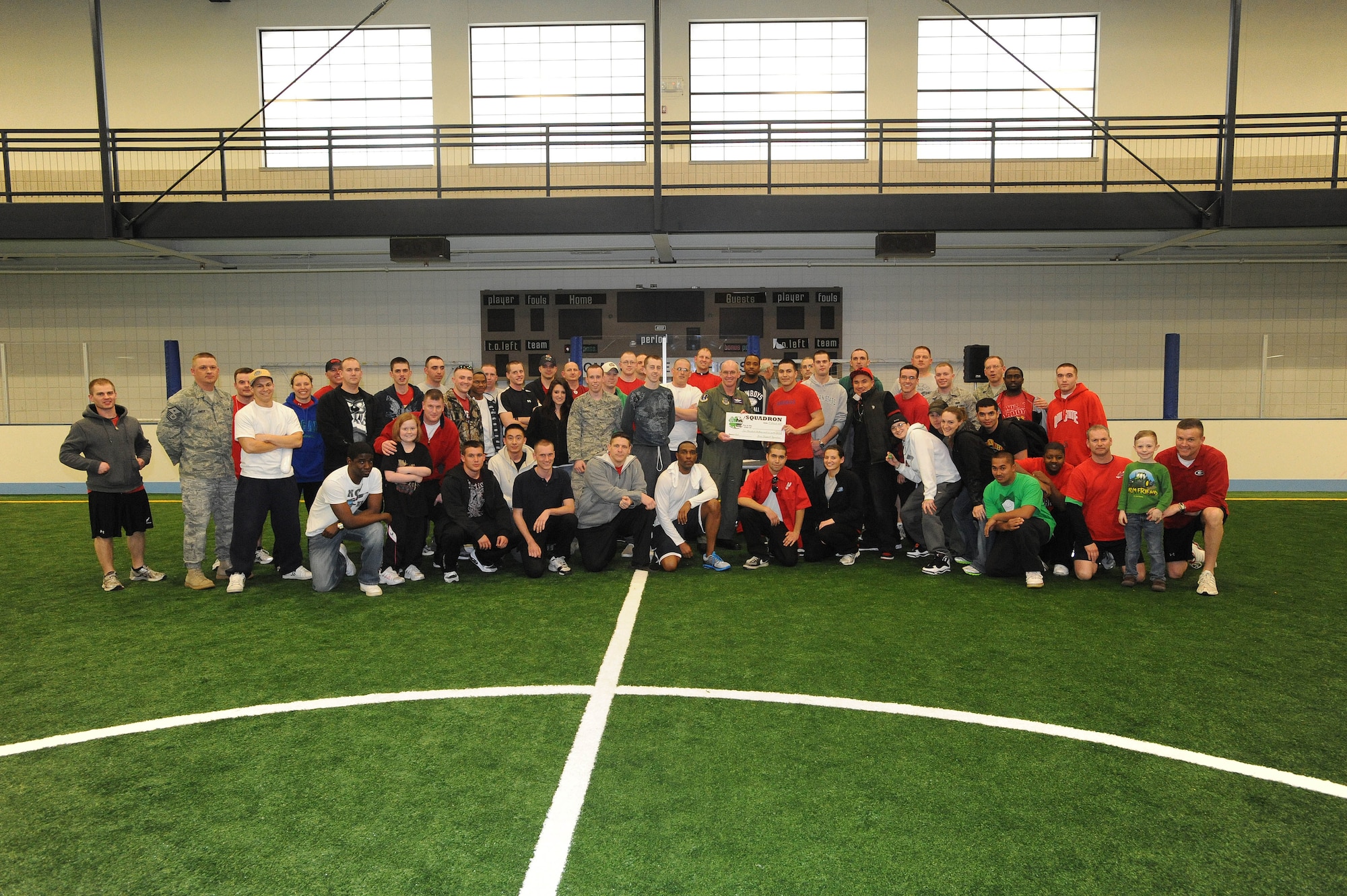 Col. John Quinn, 319th Air Base Wing vice wing commander, presents members of the 319th Civil Engineering Squadron with the first-place award Mar. 17 at the base fitness center after winning the 2011 Grand Forks Air Force Base Winter Bash. (U.S. Air Force photo by Tech. Sgt. Johnny Saldivar)