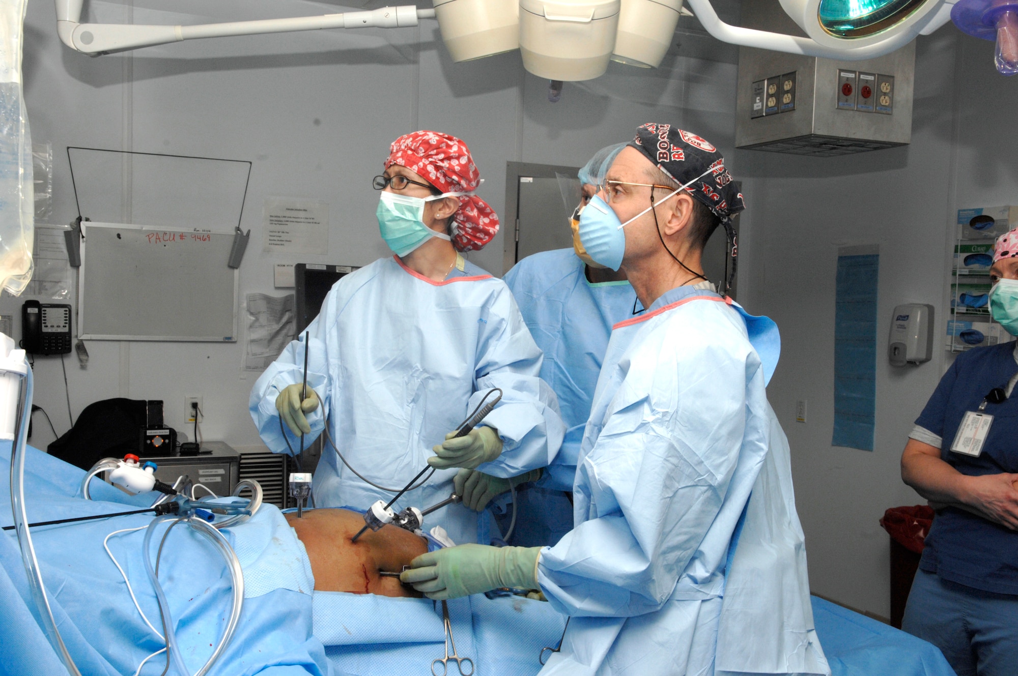 Army Lt. Col. Rob Sheridan, Navy Lt. William Ward and Maj. Kullie Pichakron, all surgeons at Craig Joint Theater Hospital, perform a cholecystectomy on a patient March 17, 2011. (U.S. Air Force photo/Senior Airman Amber R. Kelly-Heard)