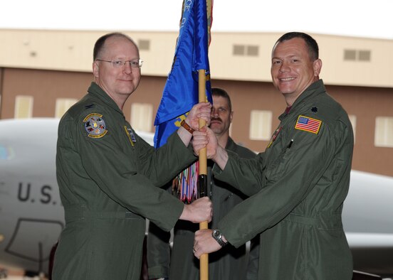 Col. Ron Langford, the previous 22nd Operations Group commander, hands the guidon to Lt. Col. Stan Lawrie, 384th Air Refueling Squadron commander, during a change of command ceremony March 18, 2011, at McConnell Air Force Base, Kan. The passing of the guidon symbolizes Colonel Lawrie assuming command from the outgoing 384th ARS, Lt. Col. Samuel Chesnut. (U.S. Air Force photo/Staff Sgt. Dallas Edwards)
