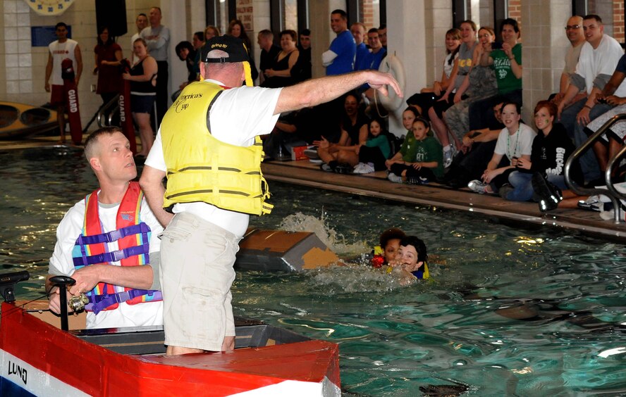 Command Chief Master Sgt. David Carlson, 319th Air Base Wing, comes to the harsh realization of what is to come as Col. John Quinn, 319th ABW vice wing commander, intentionally sends the crew overboard during the Frosty Sailor Boat Race Mar. 17 during base’s annual Winter Bash competitions at the base fitness center. (U.S. Air Force photo by Tech. Sgt. Johnny Saldivar)