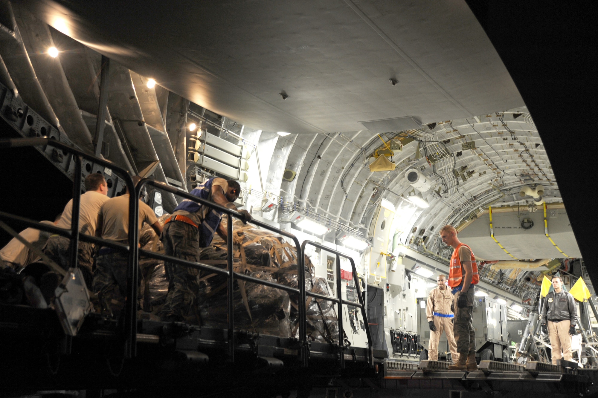 U.S. Air Force personnel load equipment into a C-17 Globemaster III, which will carry cargo and Airman to support Operation Odyssey Dawn March 20, 2011, McConnell Air Force Base, Kan. (U.S. Air Force photo/ Staff Sgt. Dallas Edwards)