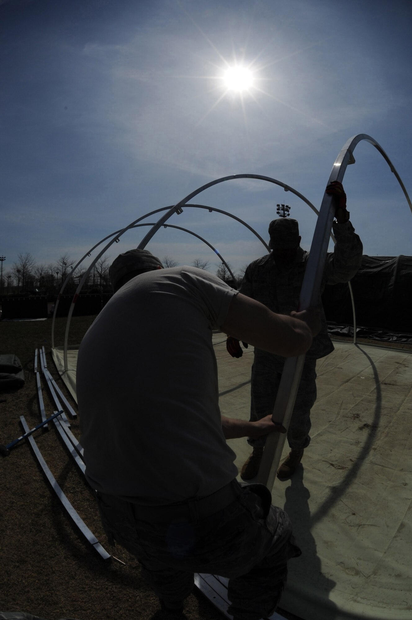 Airmen from various U.S. Air Forces in Europe civil engineer squadrons join forces to set up Alaskan small shelter tents at Aviano Air Base, Italy, March 22, 2011, in support of Operation Odyssey Dawn. Joint Task Force Odyssey Dawn is the U.S. Africa Command task force established to support the larger international response to the unrest in Libya. A broad coalition of nations are partnering to enforce U.N. Security Council Resolution (UNSCR) 1973, which authorizes all necessary means to protect civilians in Libya under threat of attack by Qadhafi regime forces.  JTF Odyssey Dawn is commanded by Admiral Samuel J. Locklear, III. (U.S. Air Force photo/ Staff Sgt. Nadine Y. Barclay)