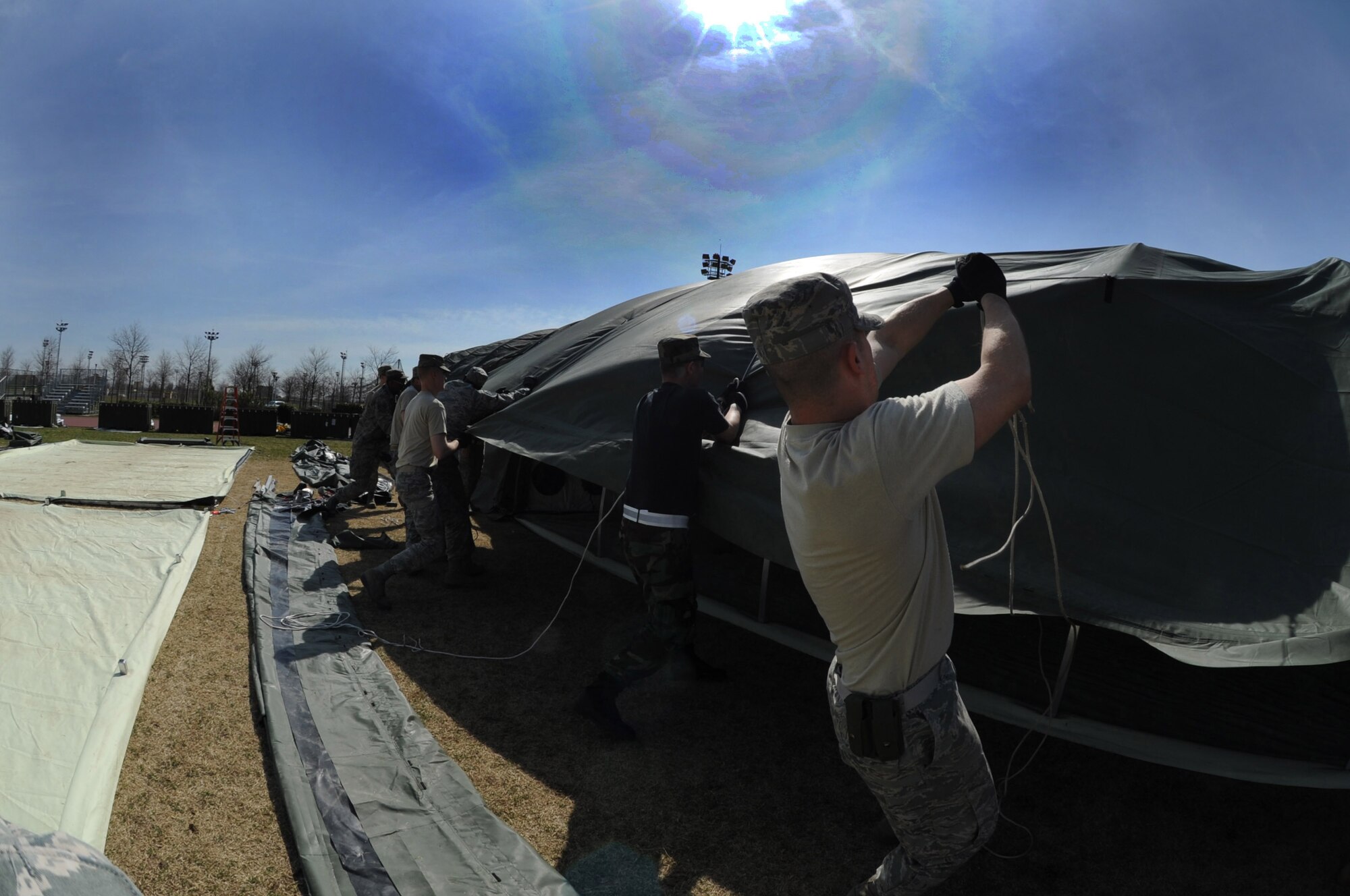 Airmen from various U.S. Air Forces in Europe civil engineer squadrons join forces to set up Alaskan small shelter tents at Aviano Air Base, Italy, March 22, 2011, in support of Operation Odyssey Dawn. Joint Task Force Odyssey Dawn is the U.S. Africa Command task force established to support the larger international response to the unrest in Libya.  A broad coalition of nations are partnering to enforce U.N. Security Council Resolution (UNSCR) 1973, which authorizes all necessary means to protect civilians in Libya under threat of attack by Qadhafi regime forces.  JTF Odyssey Dawn is commanded by Admiral Samuel J. Locklear, III. (U.S. Air Force photo/ Staff Sgt. Nadine Y. Barclay)