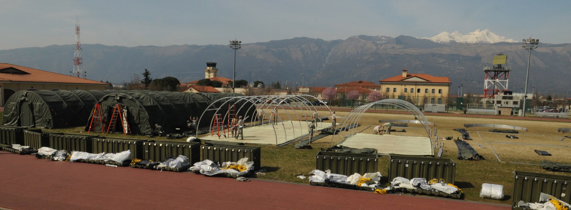 Alaskan small shelter tents line the sports field of Aviano Air Base, Italy, March 22, 2011, to house contingency personnel arriving in support of Operation Odyssey Dawn. Joint Task Force Odyssey Dawn is the U.S. Africa Command task force established to support the larger international response to the unrest in Libya.  A broad coalition of nations are partnering to enforce U.N. Security Council Resolution (UNSCR) 1973, which authorizes all necessary means to protect civilians in Libya under threat of attack by Qadhafi regime forces.  JTF Odyssey Dawn is commanded by Admiral Samuel J. Locklear, III. (U.S. Air Force photo/ Staff Sgt. Nadine Y. Barclay)