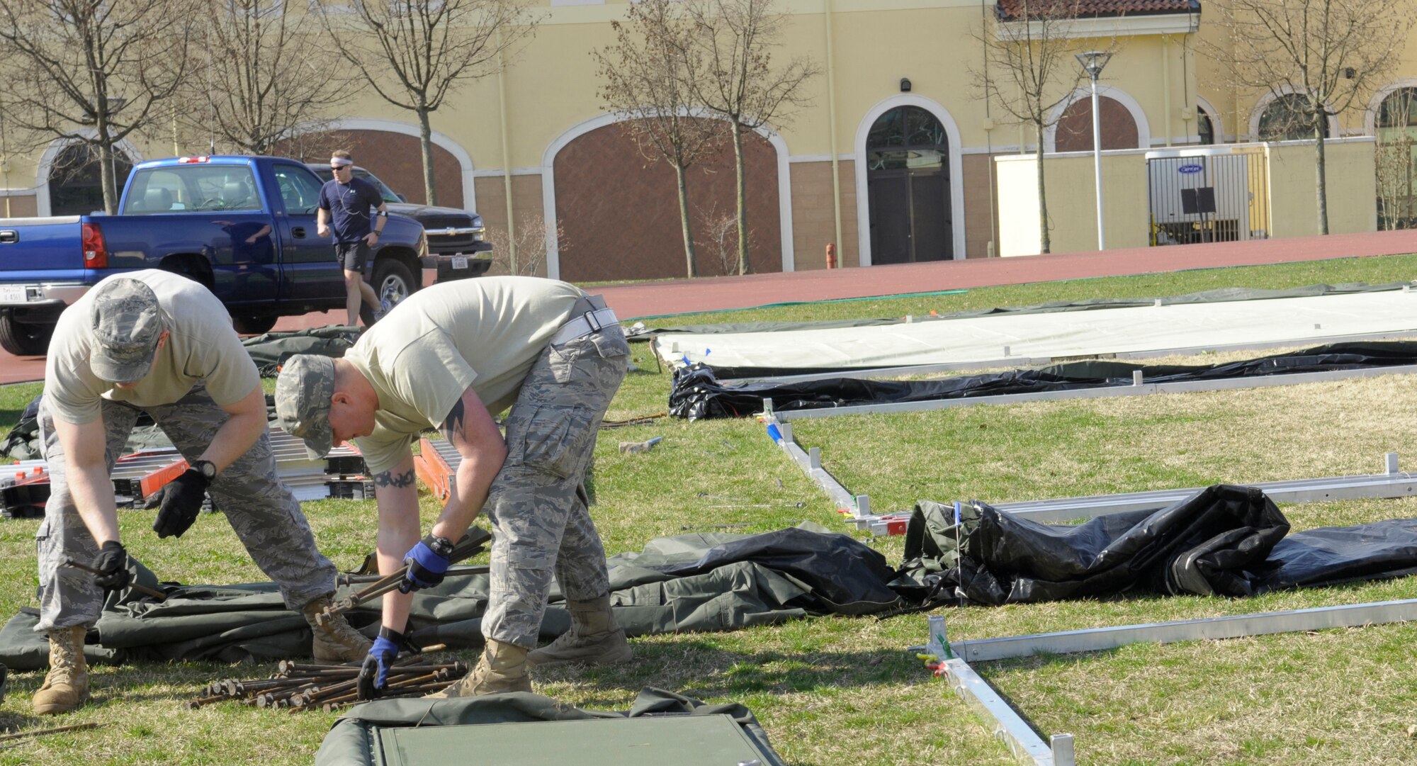 Airmen from various U.S. Air Forces in Europe civil engineer squadrons join forces to set up Alaskan small shelter tents at Aviano Air Base, Italy, March 22, 2011, in support of Operation Odyssey Dawn. Joint Task Force Odyssey Dawn is the U.S. Africa Command task force established to support the larger international response to the unrest in Libya.  A broad coalition of nations are partnering to enforce U.N. Security Council Resolution (UNSCR) 1973, which authorizes all necessary means to protect civilians in Libya under threat of attack by Qadhafi regime forces.  JTF Odyssey Dawn is commanded by Admiral Samuel J. Locklear, III. ( U.S. Air Force photo/ Airman Briana N. Jones)