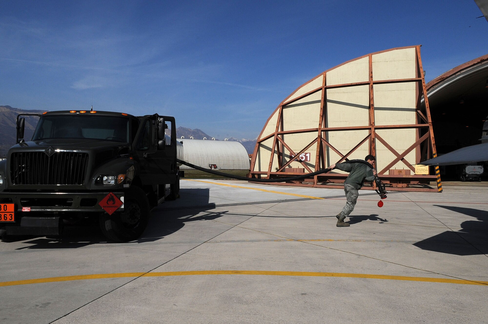 Airman 1st Class Brian Beach, a fuel specialist with 31st Logistics Readiness Squadron at Aviano Air Base, Italy, refuels an F-16 Fighting Falcon Aircraft in support of Joint Task Force Odyssey Dawn on March 22, 2011. Joint Task Force Odyssey Dawn is the U.S. Africa Command Task force established to support the larger international response to the unrest in Libya. A broad coalition of nations are partnering to enforce U.N. Security Council Resolution (UNSCR) 1973, which authorizes all necessary means to protect civilians in Libya under threat of attack by Qadhafi regime forces.  JTF Odyssey Dawn is commanded by Admiral Samuel J. Locklear, III.  (US Army Photo by SSG Tierney P. Wilson)