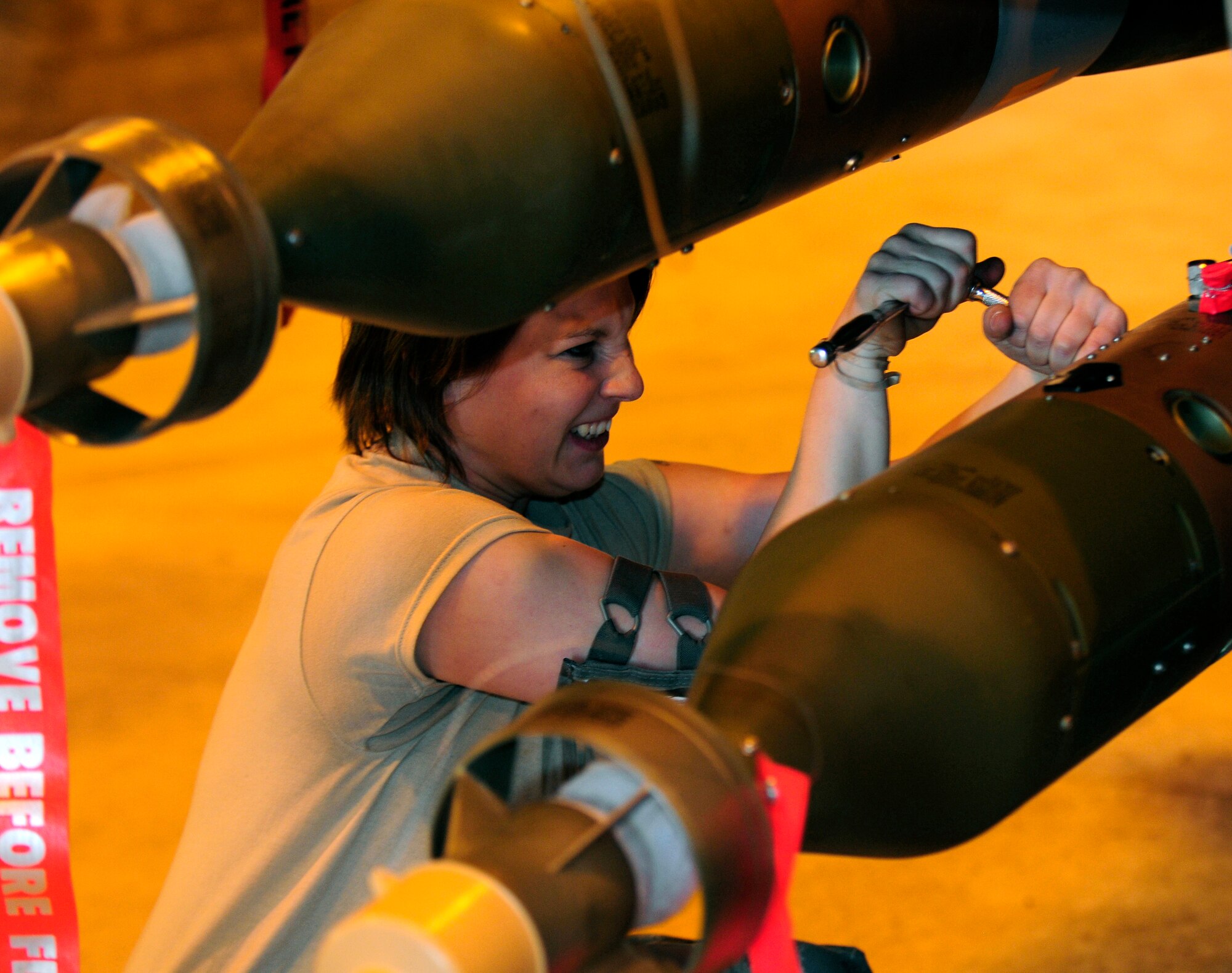Airman 1st Class Katelynn Michalko, 510th Aircraft Maintenance Unit weapons load crew member, ensures an ordinance is secure on an F-16 Fighting Falcon March 21, 2011, at Aviano Air Base, Italy. The aircraft will deploy in support of Operation Odyssey Dawn.  Joint Task Force Odyssey Dawn is the U.S. Africa Command task force established to support the larger international response to the unrest in Libya.  A broad coalition of nations are partnering to enforce U.N. Security Council Resolution (UNSCR) 1973, which authorizes all necessary means to protect civilians in Libya under threat of attack by Qadhafi regime forces.  JTF Odyssey Dawn is commanded by Admiral Samuel J. Locklear, III. (U.S. Air Force photo by Airman 1st Class Katherine Windish)