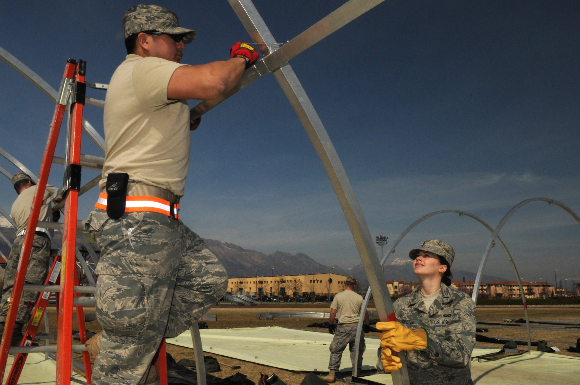 Tech. Sgt. Selvin Hudson, 48th Civil Engineer Squadron structural craftsman from Royal Air Force Lakenheath, United Kingdom, and 1st Lt. Elizabeth Hoeltje, 31st Mission Support Group executive officer, build Alaskan small shelter tents March 22, 2011, for contingency personnel arriving to Aviano Air Base, Italy, in support of Operation Odyssey Dawn. Joint Task Force Odyssey Dawn is the U.S. Africa Command task force established to support the larger international response to the unrest in Libya.  A broad coalition of nations are partnering to enforce U.N. Security Council Resolution (UNSCR) 1973, which authorizes all necessary means to protect civilians in Libya under threat of attack by Qadhafi regime forces.  JTF Odyssey Dawn is commanded by Admiral Samuel J. Locklear, III.  (U.S. Air Force photo/ Staff Sgt. Nadine Y. Barclay)