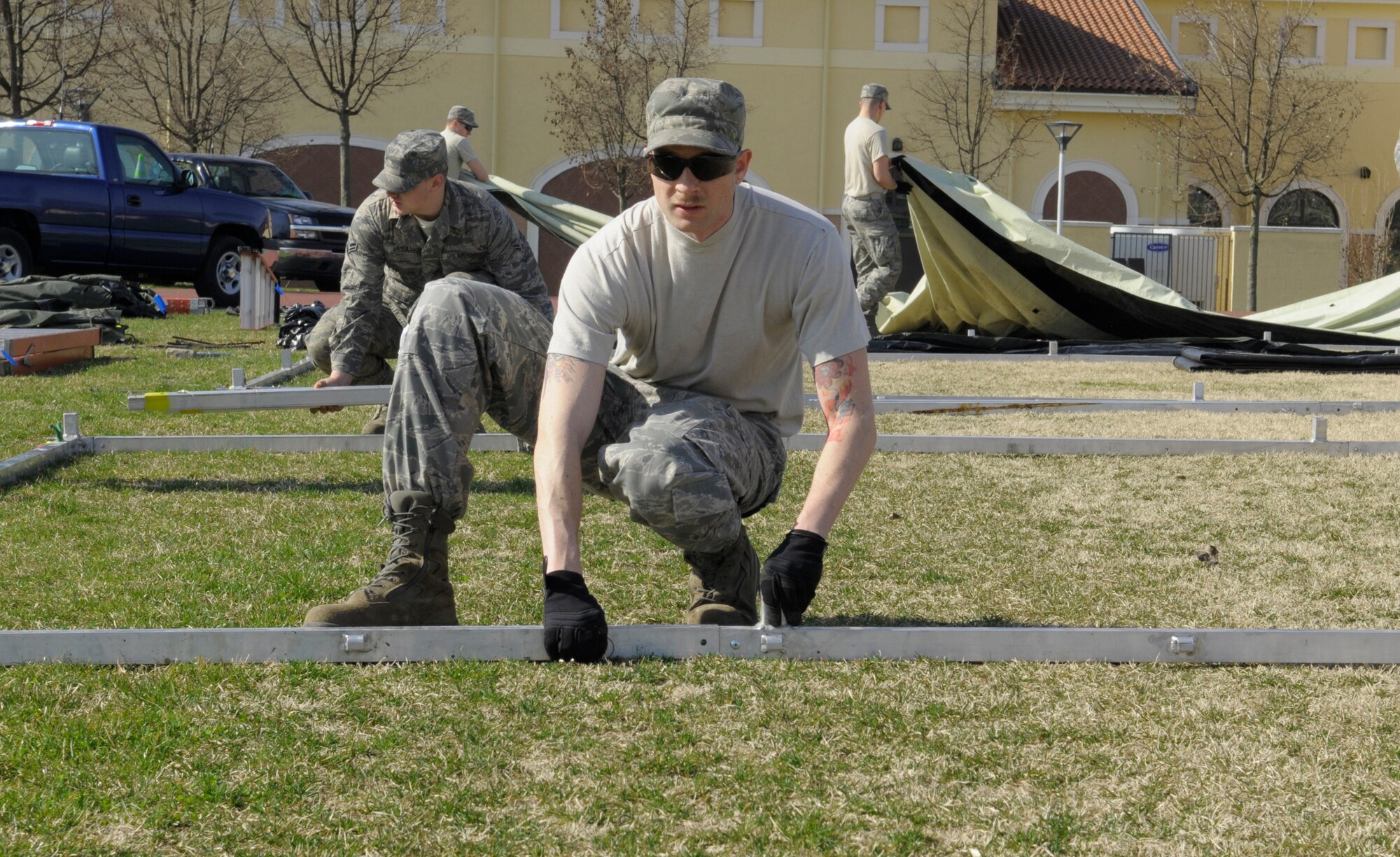Airmen from various U.S. Air Forces in Europe civil engineer squadrons join forces to set up Alaskan small shelter tents at Aviano Air Base, Italy, March 22, 2011, in support of Operation Odyssey Dawn. Joint Task Force Odyssey Dawn is the U.S. Africa Command task force established to support the larger international response to the unrest in Libya.  A broad coalition of nations are partnering to enforce U.N. Security Council Resolution (UNSCR) 1973, which authorizes all necessary means to protect civilians in Libya under threat of attack by Qadhafi regime forces.  JTF Odyssey Dawn is commanded by Admiral Samuel J. Locklear, III. (U.S. Air Force photo/ Airman Briana Jones)