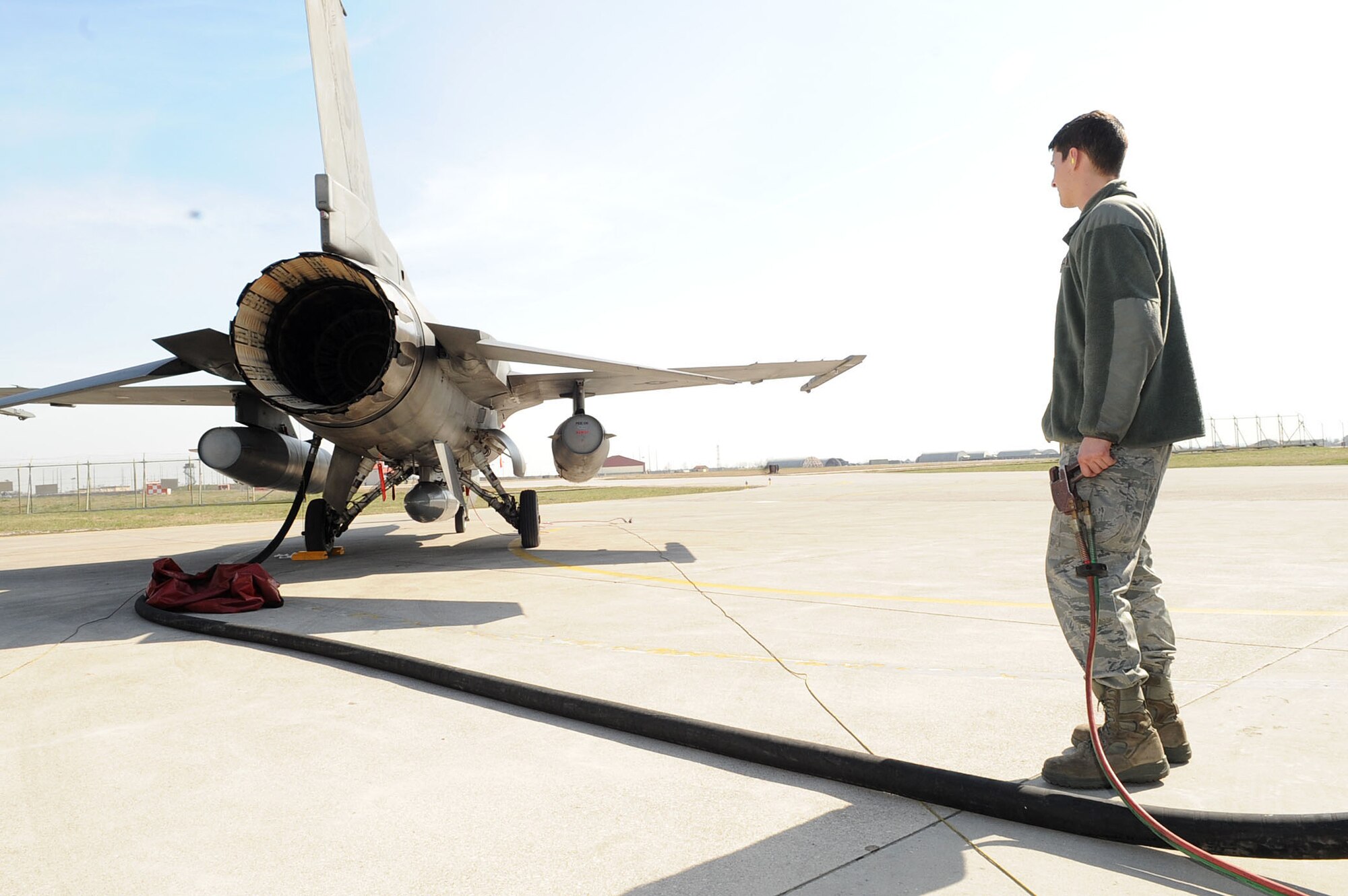 Airman 1st Class Brian Beach, a fuel specialist with 31st Logistics Readiness Squadron at Aviano Air Base, Italy, refuels an F-16 Fighting Falcon in support of Joint Task Force Odyssey Dawn March 22, 2011. Joint Task Force Odyssey Dawn is the U.S. Africa Command Task force established to support the larger international response to the unrest in Libya. A broad coalition of nations are partnering to enforce U.N. Security Council Resolution (UNSCR) 1973, which authorizes all necessary means to protect civilians in Libya under threat of attack by Qadhafi regime forces.  JTF Odyssey Dawn is commanded by Admiral Samuel J. Locklear, III.  (US Army Photo by SSG Tierney P. Wilson)