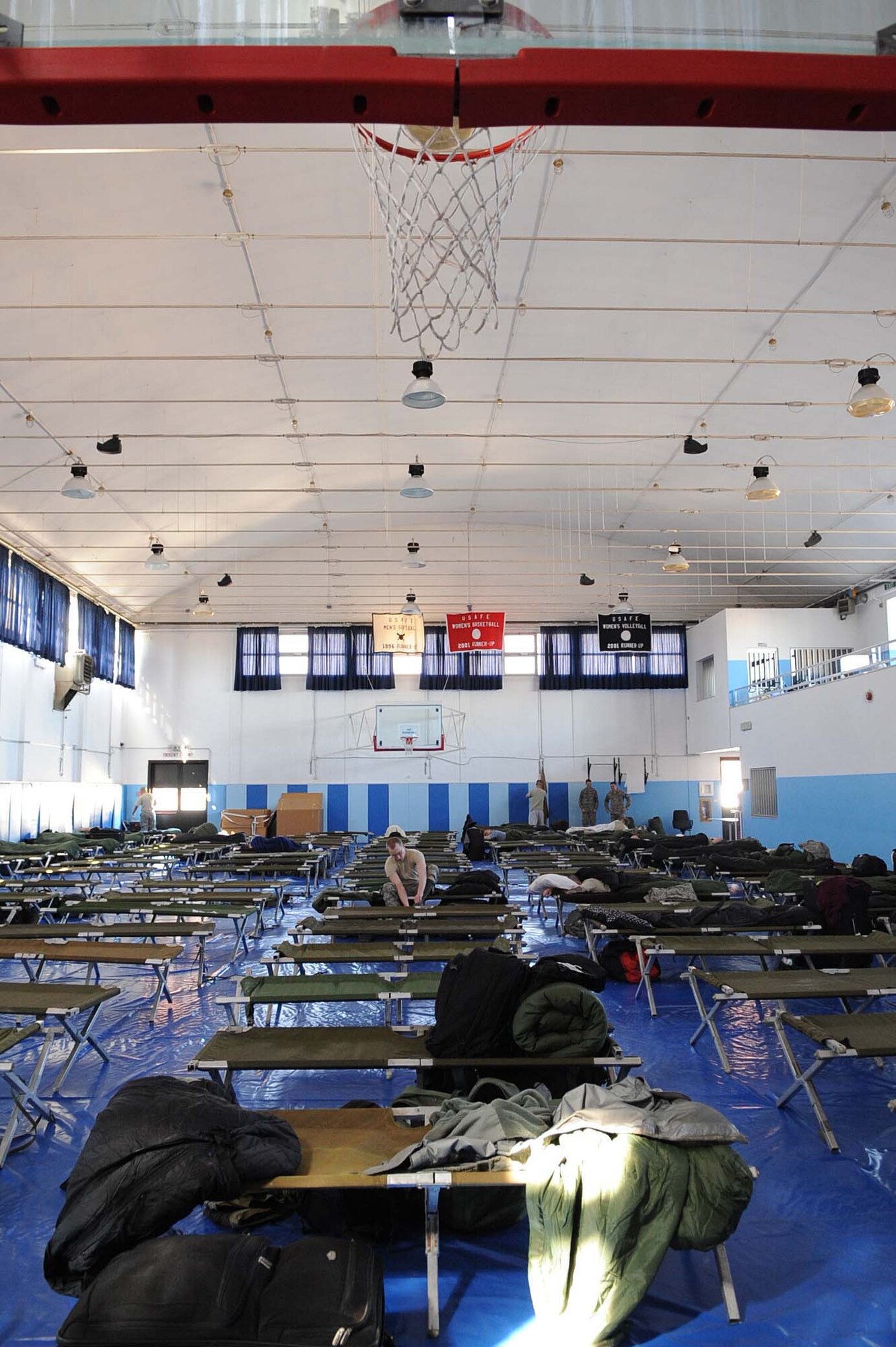 Servicemembers from the Navy and Air Force deployed to Aviano Air Force Base, Italy, in support of Joint Task Force Odyssey Dawn temporarily reside in the Falcon Fitness Center on March 21, 2011. Joint Task Force Odyssey Dawn is the U.S. Africa Command Task force established to support the larger international response to the unrest in Libya. A broad coalition of nations are partnering to enforce U.N. Security Council Resolution (UNSCR) 1973, which authorizes all necessary means to protect civilians in Libya under threat of attack by Qadhafi regime forces.  JTF Odyssey Dawn is commanded by Admiral Samuel J. Locklear, III.  (US Army Photo by SSG Tierney P. Wilson)

