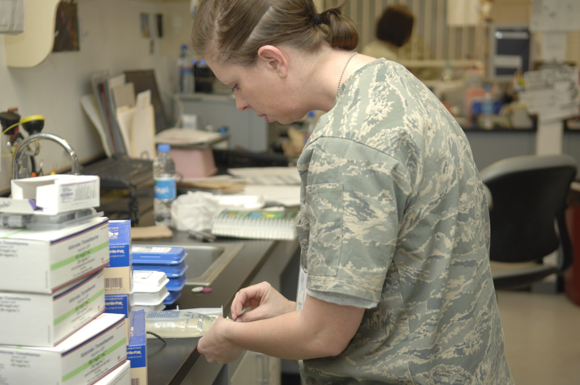 Capt. Jennifer Baker, Craig Joint Theater Hospital Pharmacy commander, prepares an IV for a patient. Captain Baker is married and has three children. (U.S. Air Force photo/Senior Airman Amber R. Kelly-Herard) 