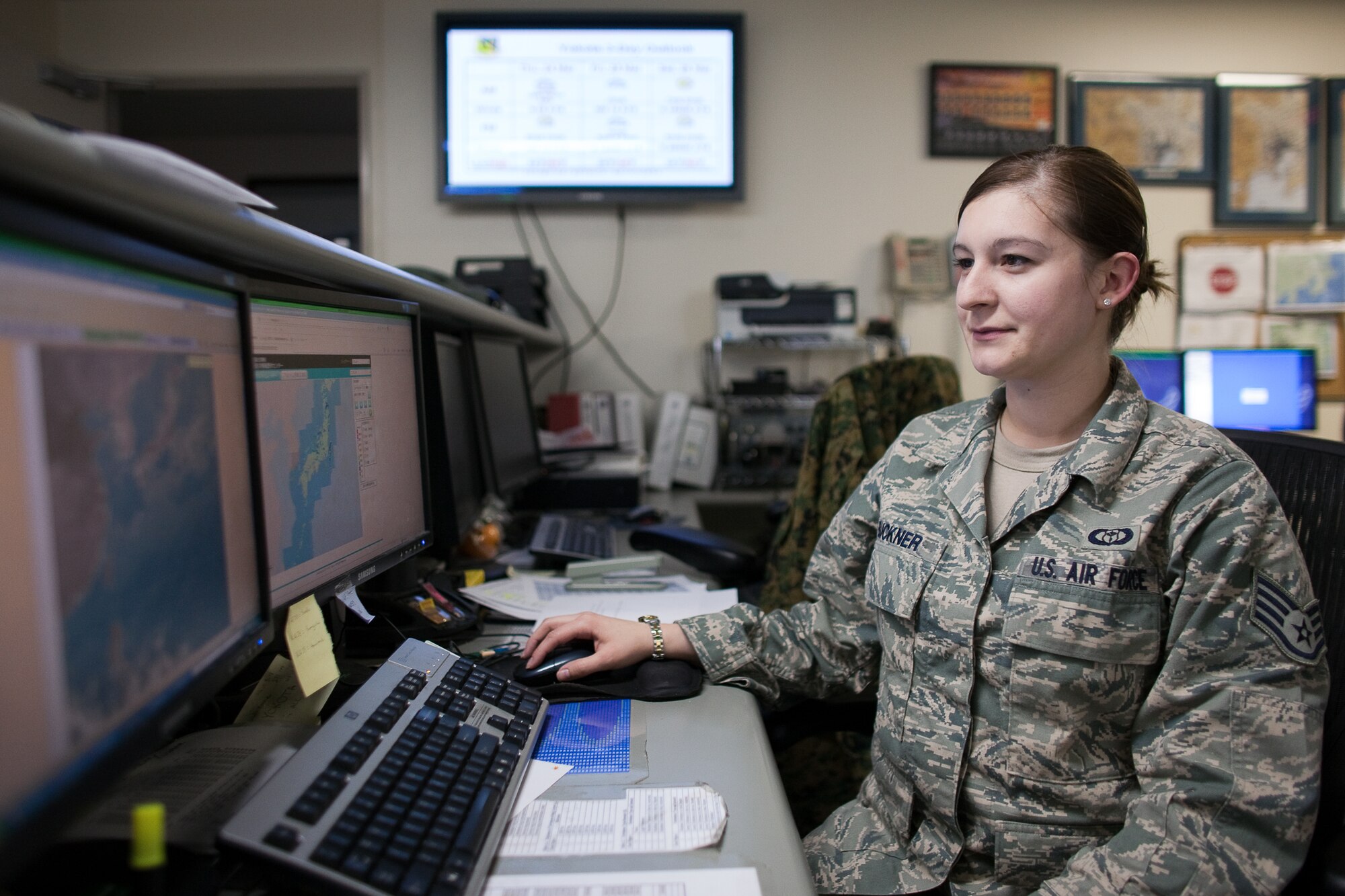 YOKOTA AIR BASE, Japan -- Staff Sgt. Eryn Buckner, 374th Operations Support Squadron, checks the current weather conditions before briefing pilots at Yokota Air Base, Japan, March 24. A native of Kerrville, Texas, Sergeant Buckner briefs aircrew members on weather conditions prior to operations. The number of flights here has increased dramatically since the start of Operation Tomodachi, March 11. (U.S. Air Force photo/Osakabe Yasuo)