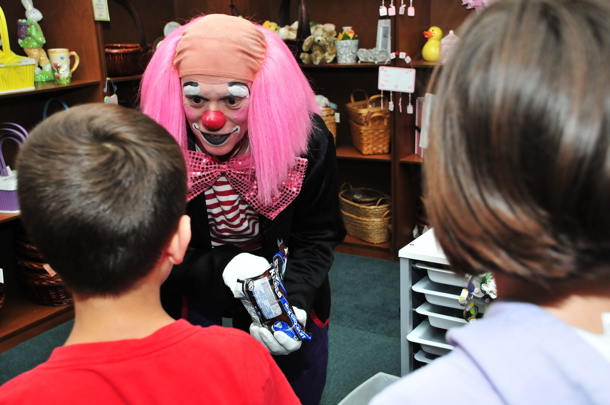 A clown entertains children at the Incirlik Community Center during the “Kids Karnival” March 16, 2011, at Incirlik Air Base, Turkey.  During the carnival, families spent time together playing games, eating and participating in other activities. This event was held to boost the morale of Airmen and their families here at Incirlik, officials said.  (U.S. Air Force photo by Staff Sgt. Alexandre Montes/Released)