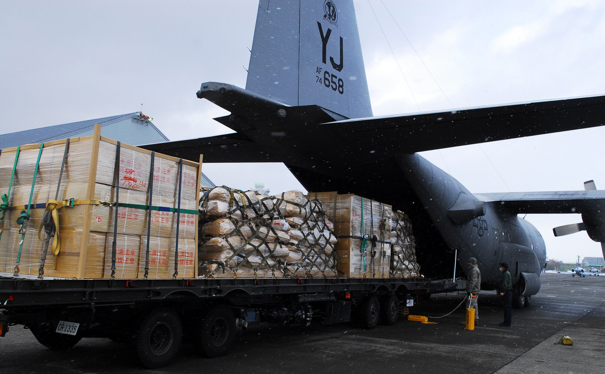 CHITOSE AIR BASE, Japan -- A C-130 Hercules assigned to the 36th Airlift Squadron at Yokota Air Base, Japan, prepares to transport humanitarian relief supplies from Chitose Air Base, Japan, to Matsushima, Japan, March 23. The six pallets that were transported contained 15,000 pounds of water, rice and blankets. (U.S. Air Force photo/Staff Sgt. Robin Stanchak)