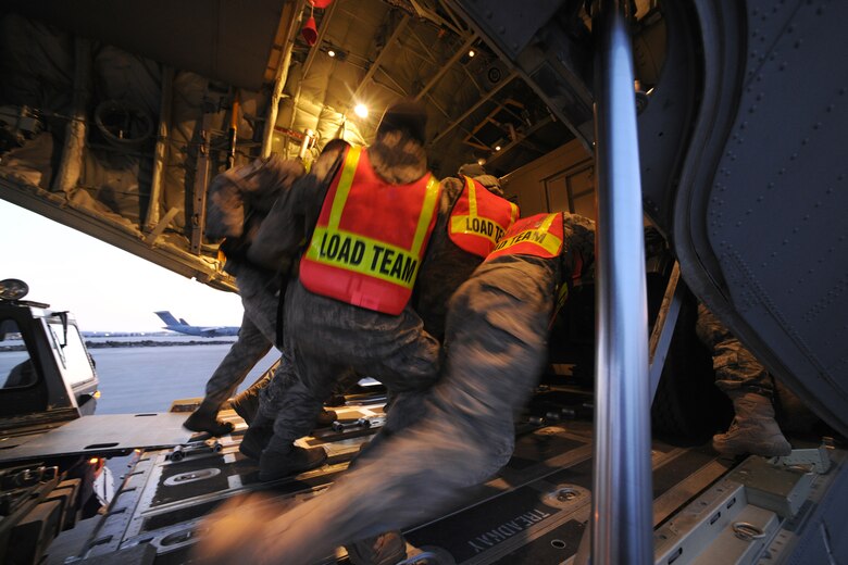 SPANGDAHLEM AIR BASE, Germany – Airmen from the 726th Air Mobility and 52nd Logistics Readiness Squadrons load cargo into a C-130J Super Hercules here in support of Odyssey Dawn March 21. Joint Task Force Odyssey Dawn is the U.S. Africa Command task force established to provide operational and tactical command and control of U.S. military forces supporting the international response to the unrest in Libya and enforcement of United Nations Security Council Resolution (UNSCR) 1973. UNSCR 1973 authorizes all necessary measures to protect civilians in Libya under threat of attack by Qadhafi regime forces.  JTF Odyssey Dawn is commanded by U.S. Navy Admiral Samuel J. Locklear, III. (U.S. Air Force photo/Senior Airman Nathanael Callon)